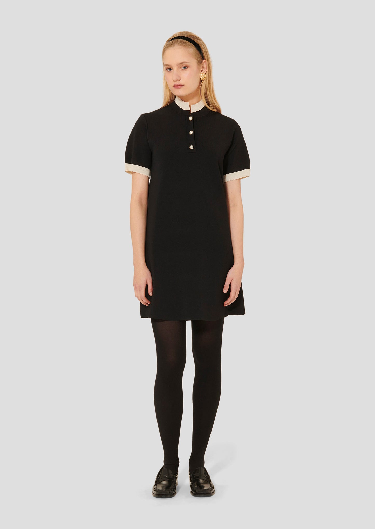 Straight cut short black dress with a small stand-up collar and short sleeves.