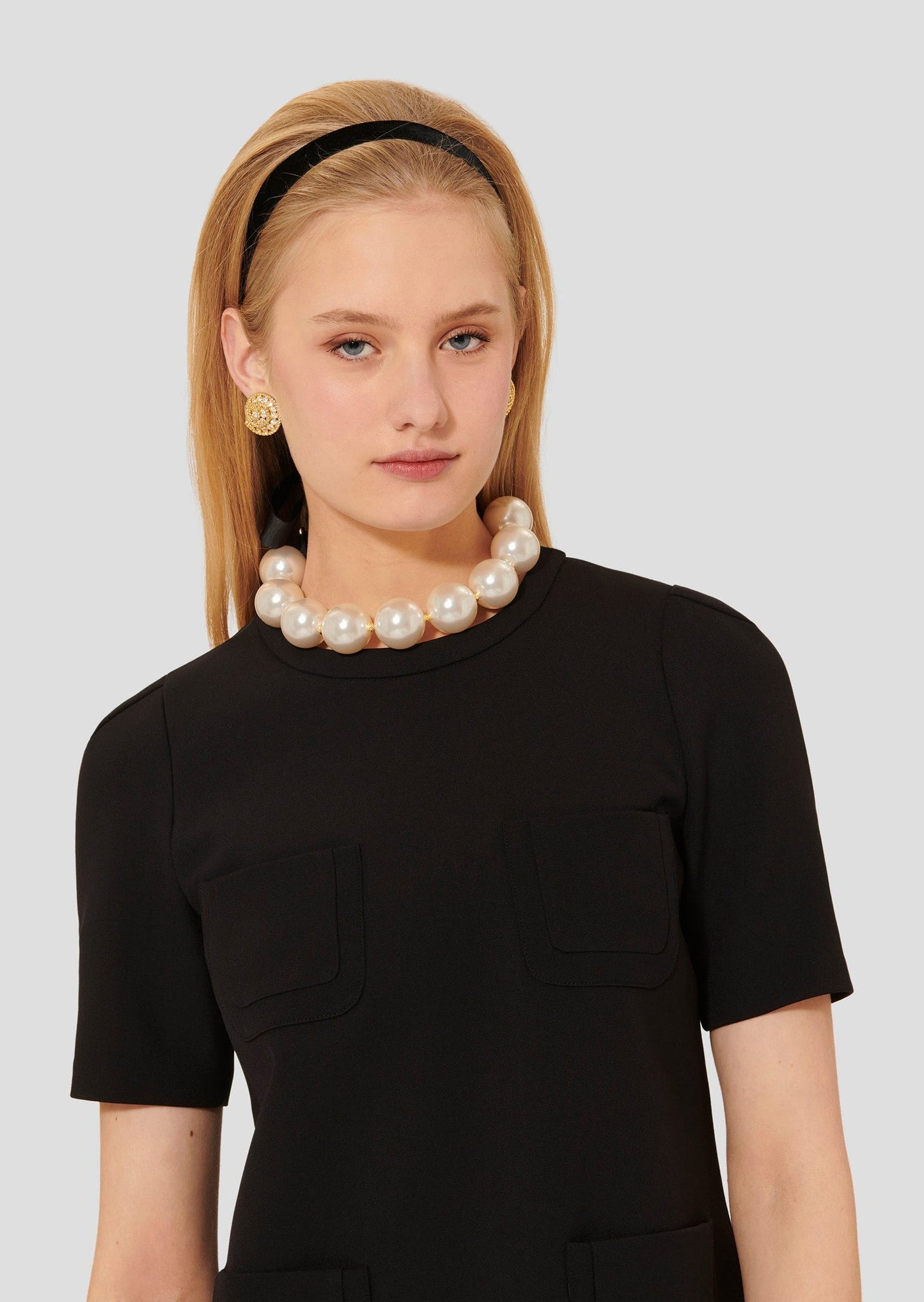 Short Sleeves Black Dress with a Round Neckline and Patch Pockets.