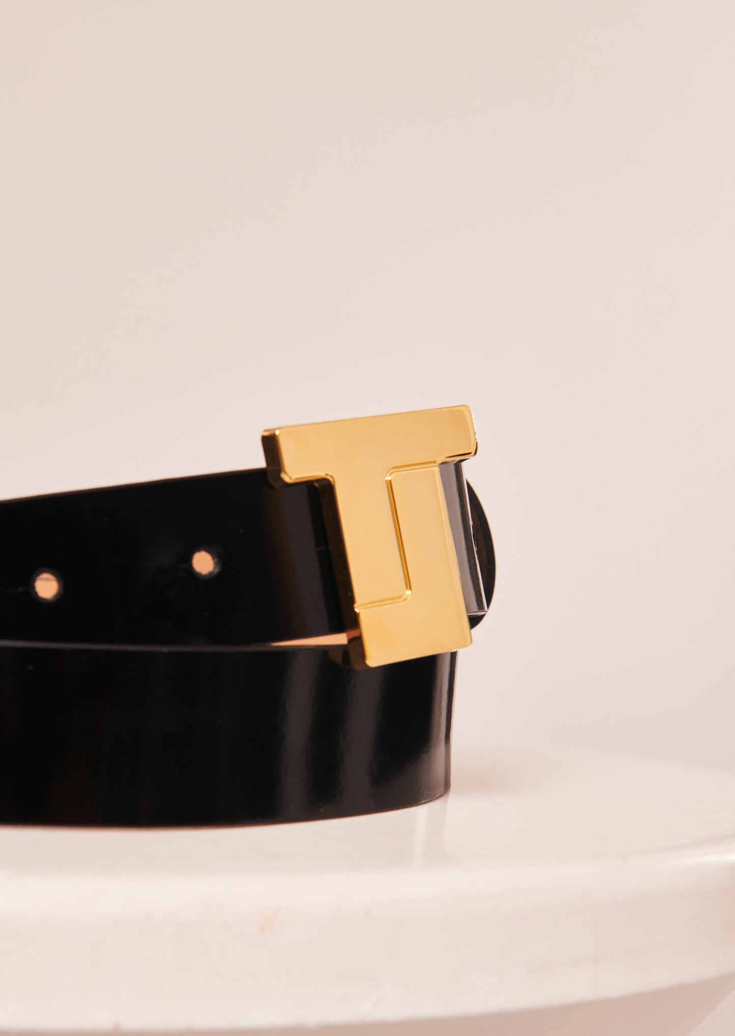 Gold buckle leather belt.