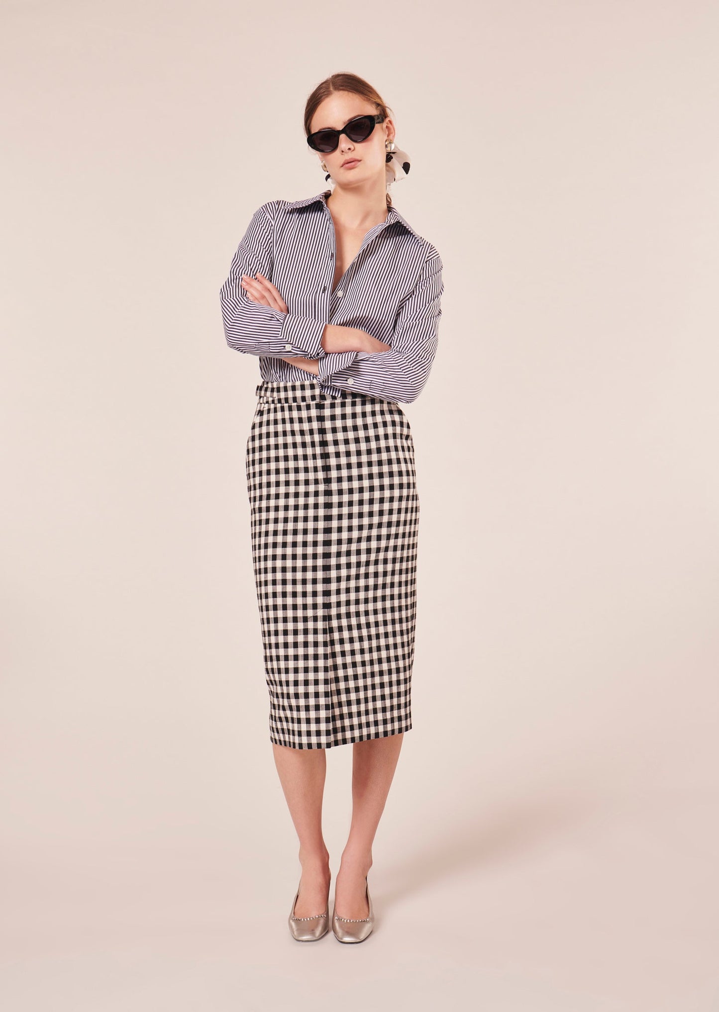 Model wearing Tara Jarmon a black mid-length pencil cut skirt.