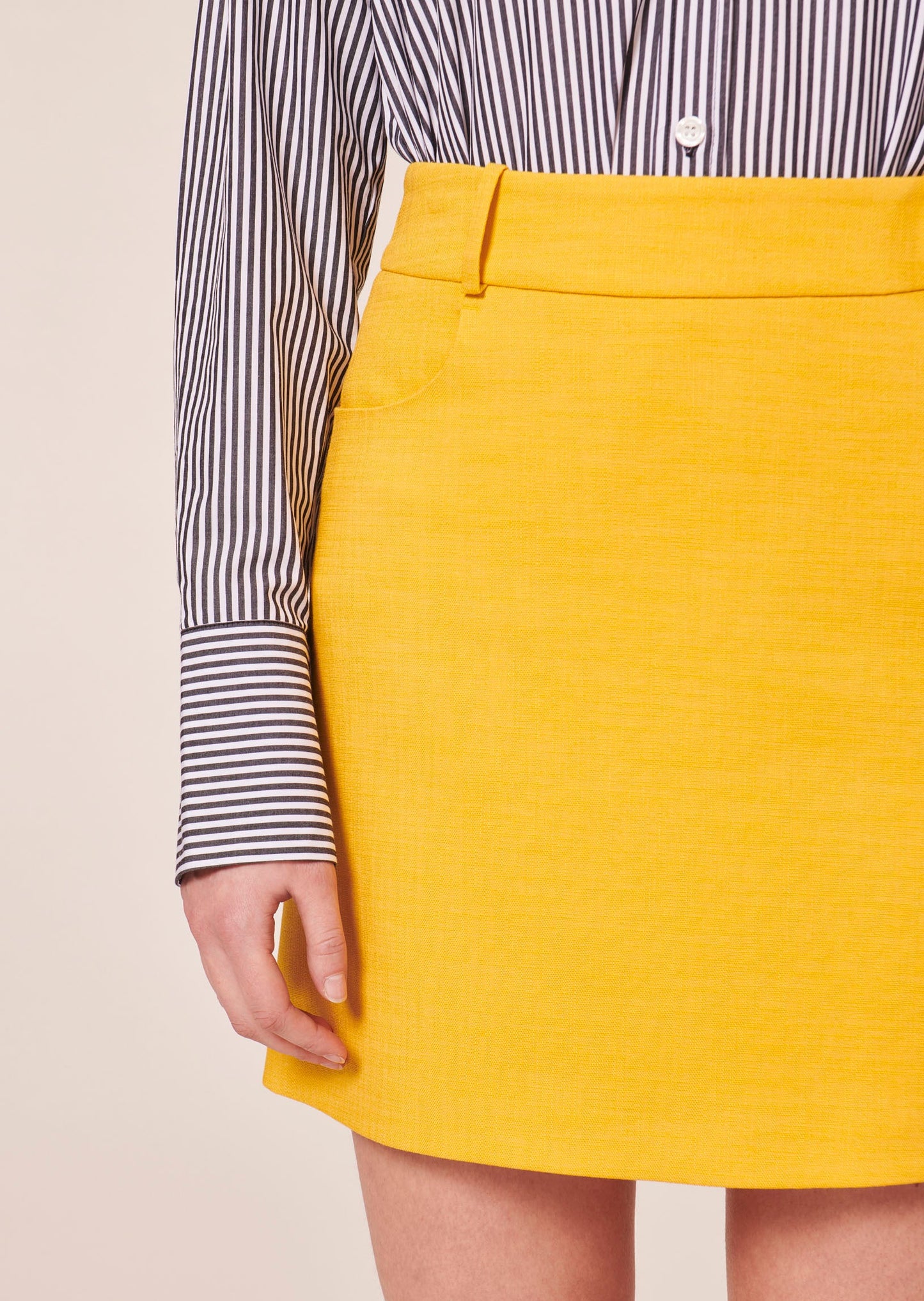 Modern yellow skirt with straight cut and belt loops.