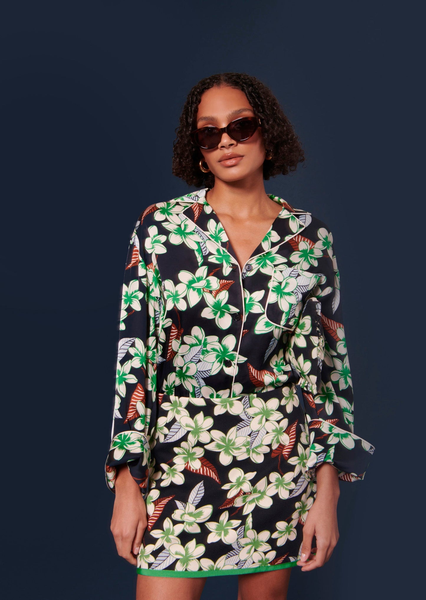 Midnight blue short skirt with floral print and matching shirt.