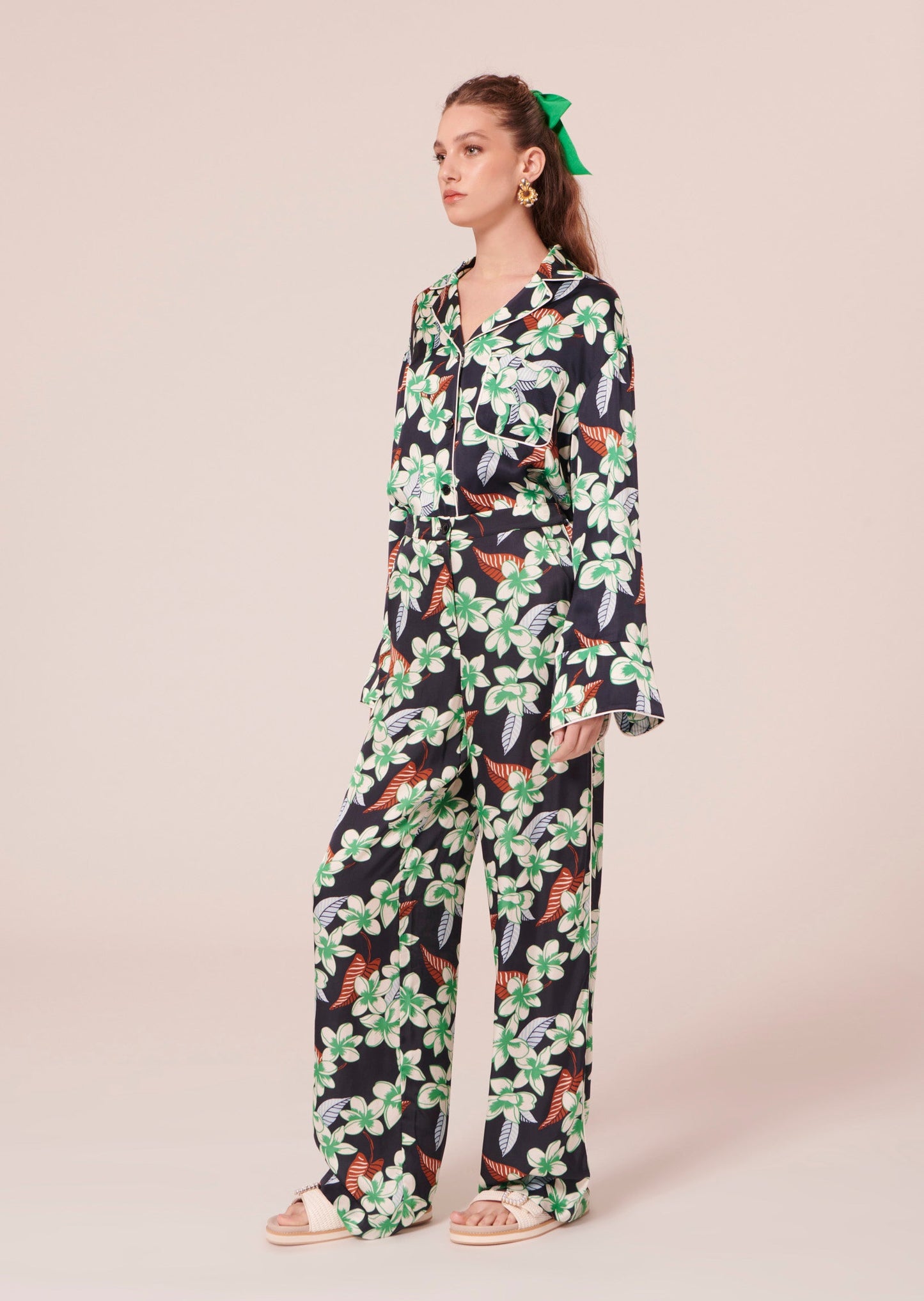 Model wearing Tara Jarmon midnight blue pants with flower print.