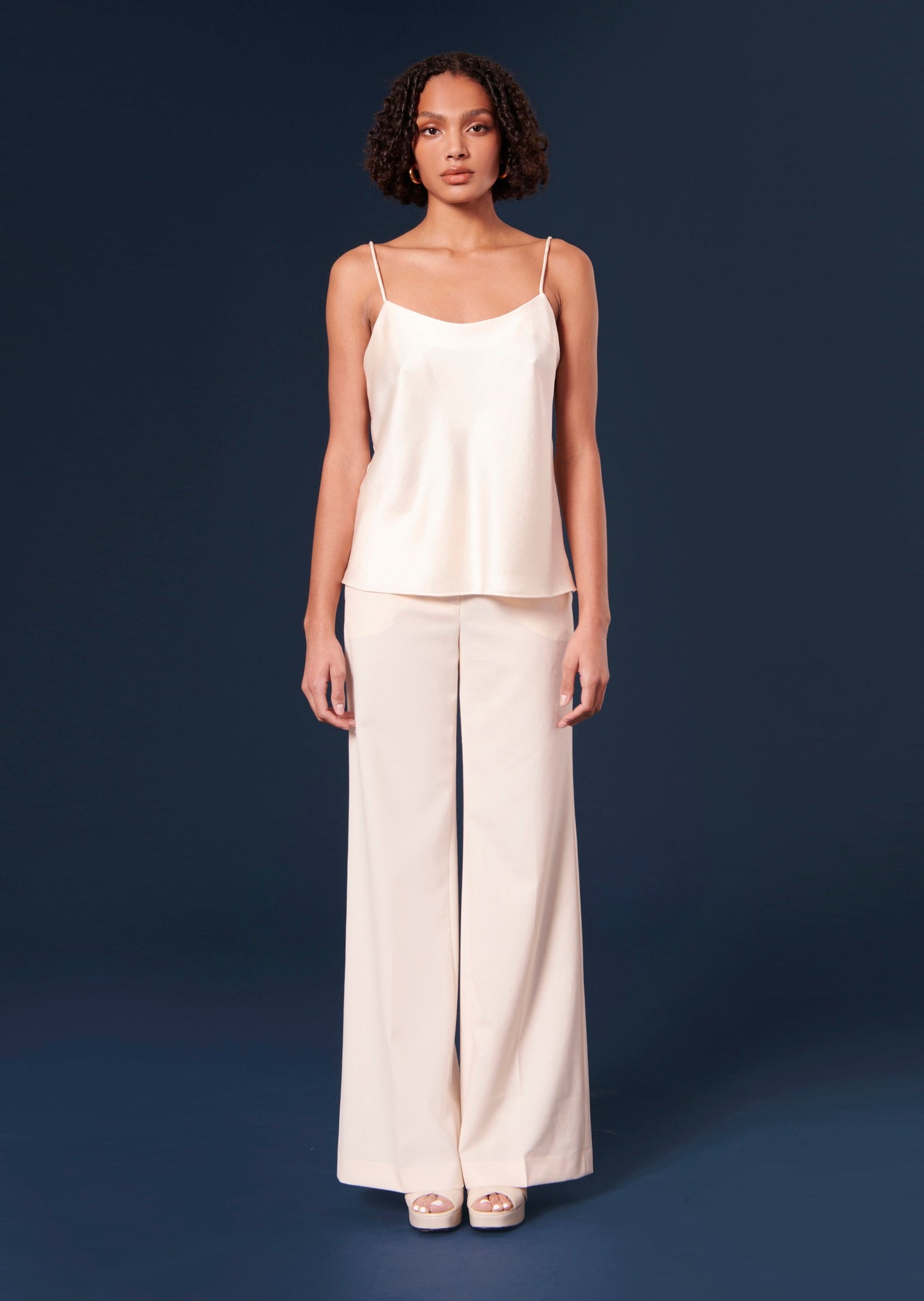 Off-white cold wool, wide flared cut pants, with side pockets.