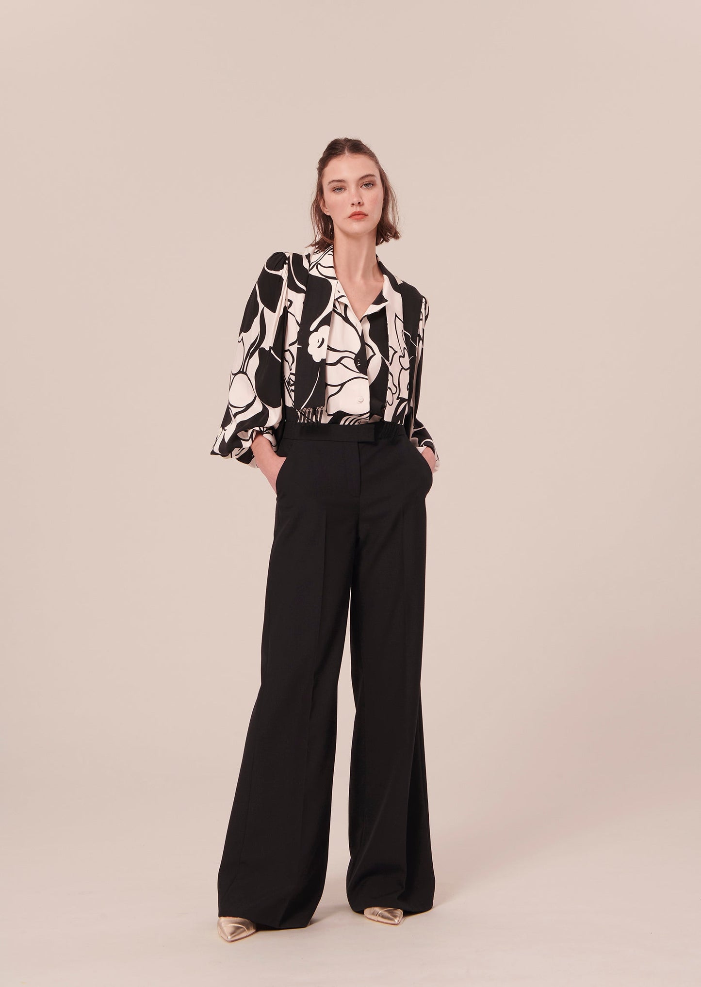 Model wearing Tara Jarmon wide cut black pants.