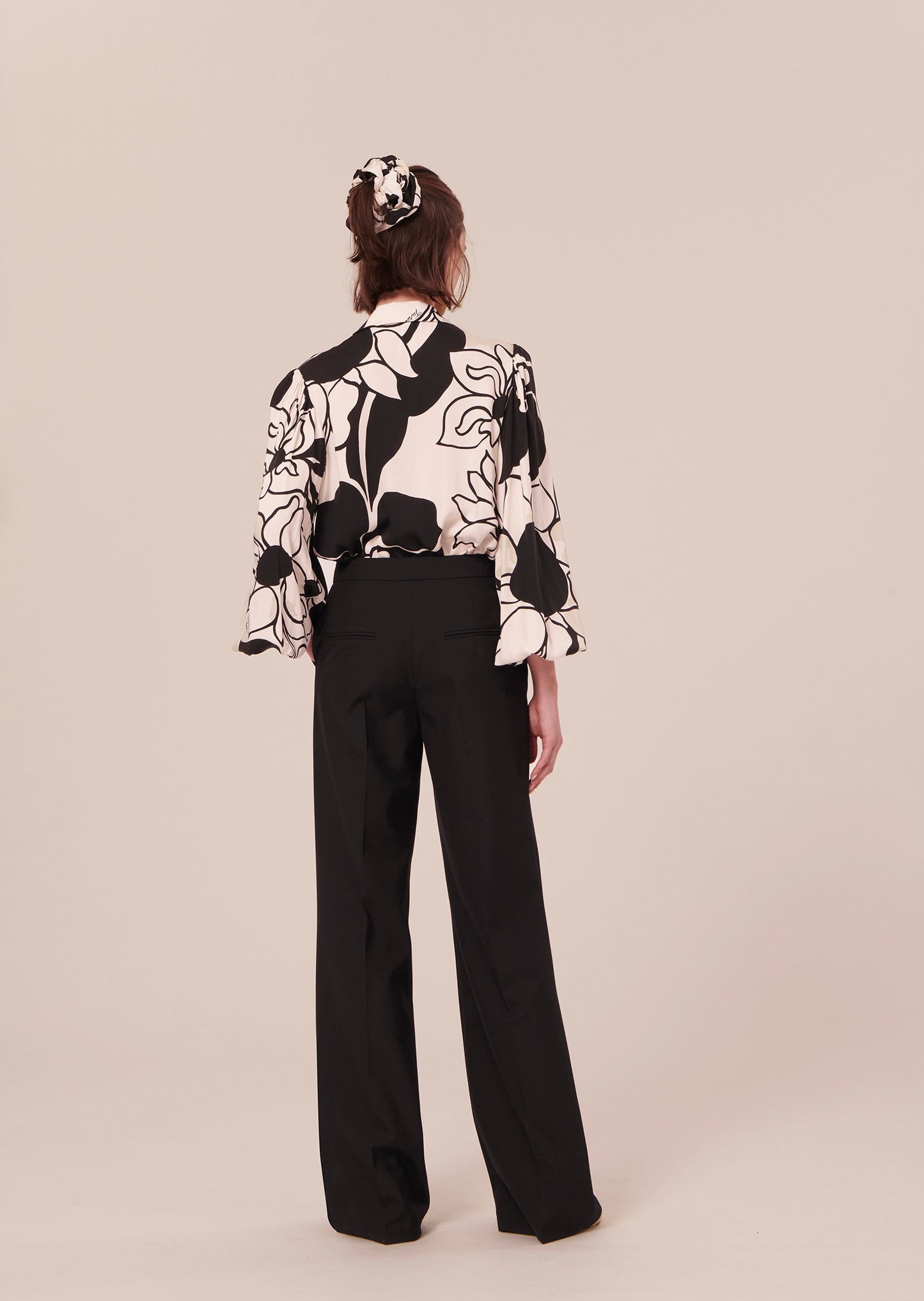 Black pants with welt pockets on the back.