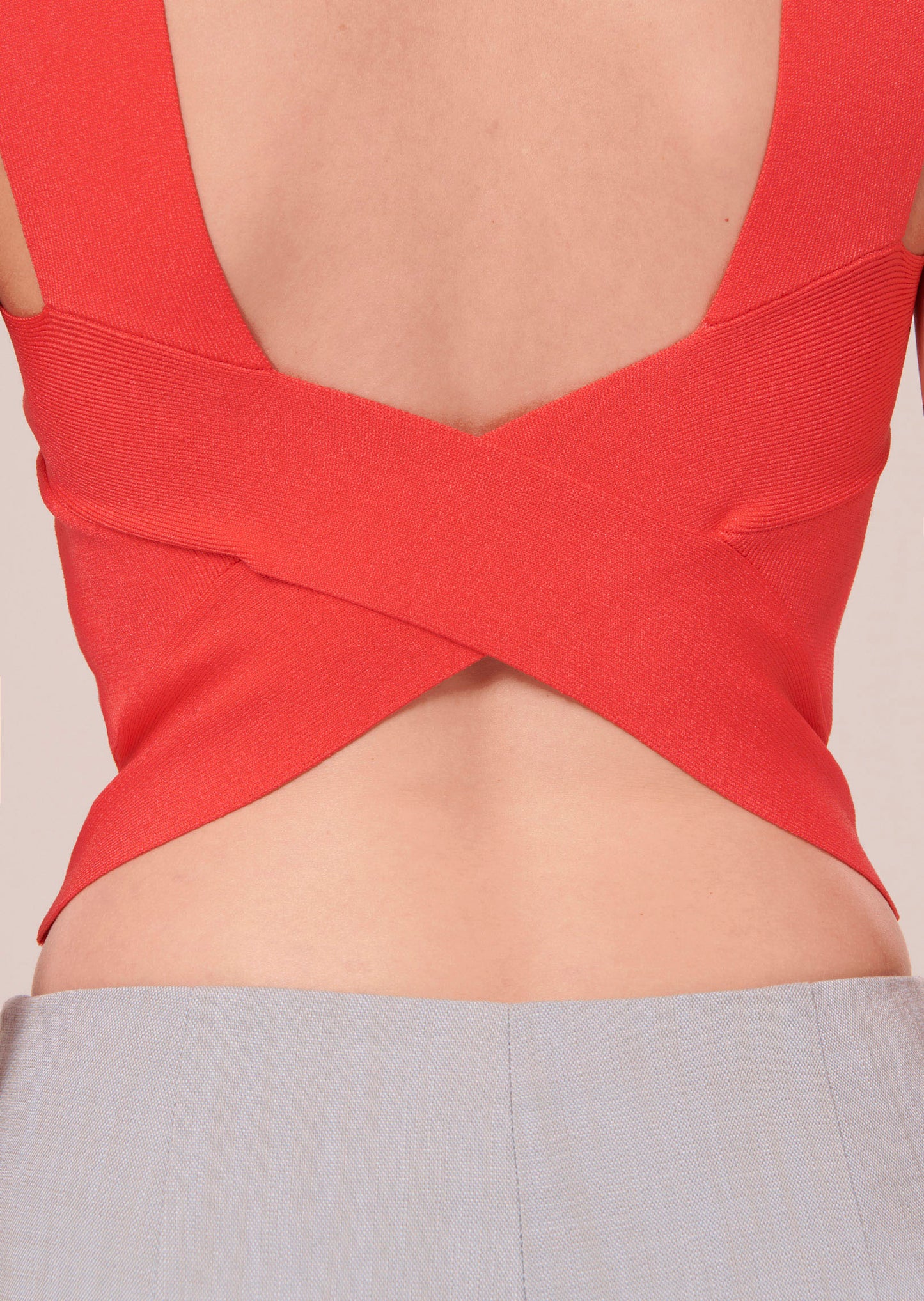 Coral crop top with elegant revealing back.