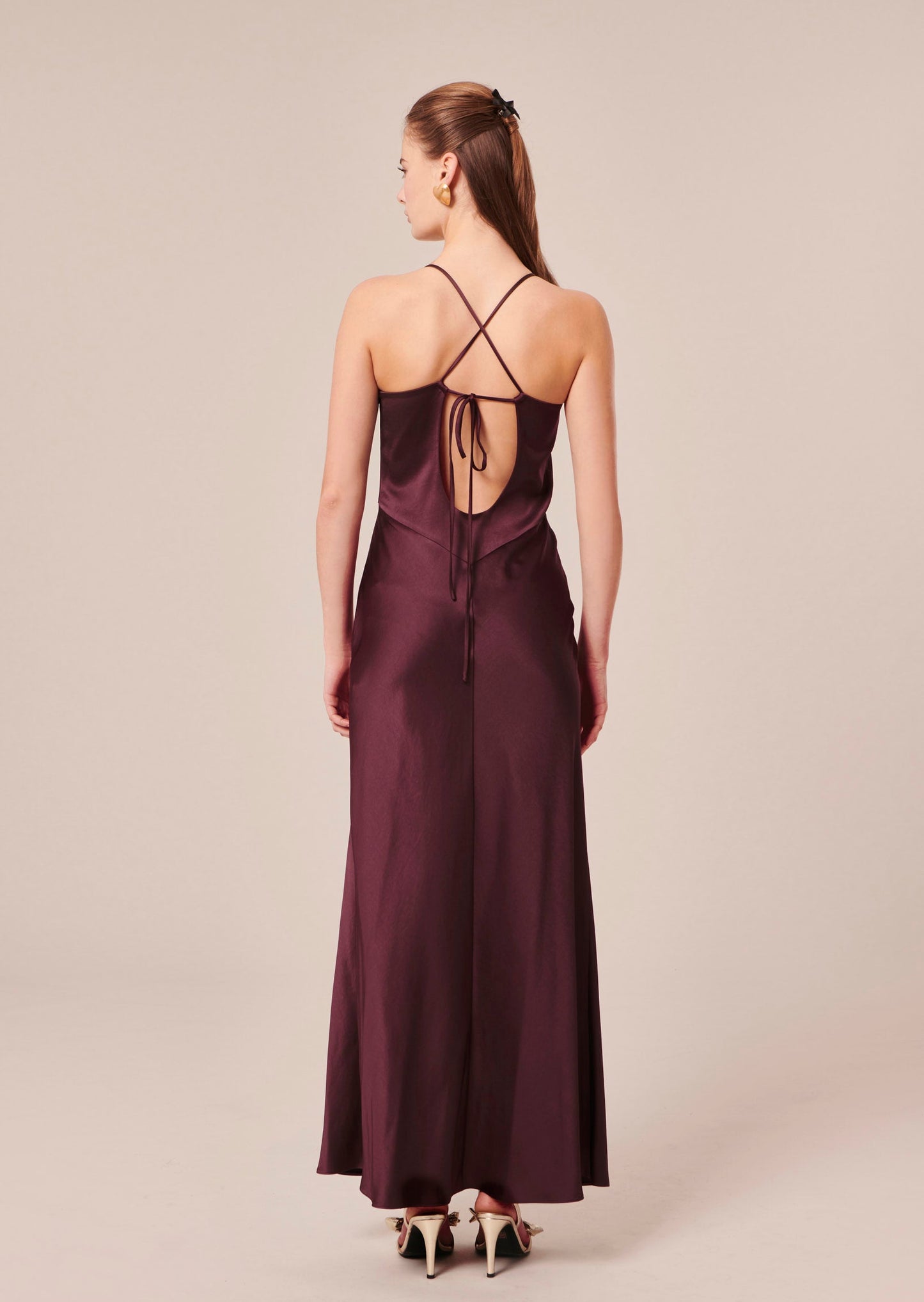 Model wearing Tara Jarmon Flowing Satin Maxi Dress in Chocolate with Tie Back.