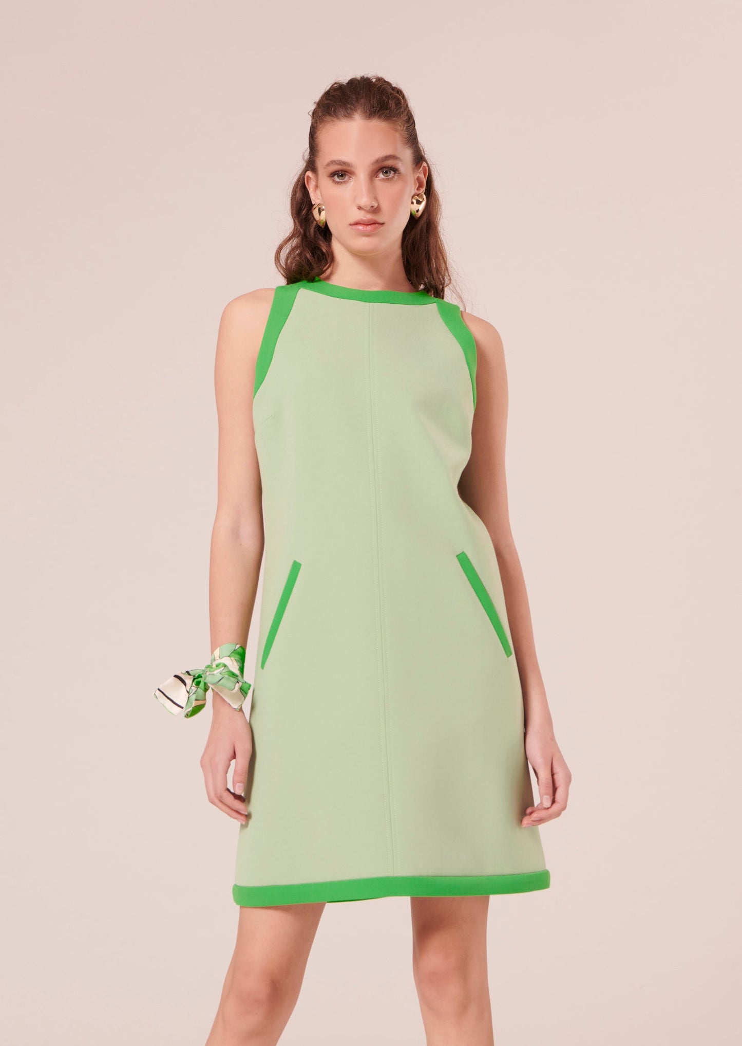 Model wearing Tara Jarmon Green Mini Dress with Contrast Trim and Round Neckline.