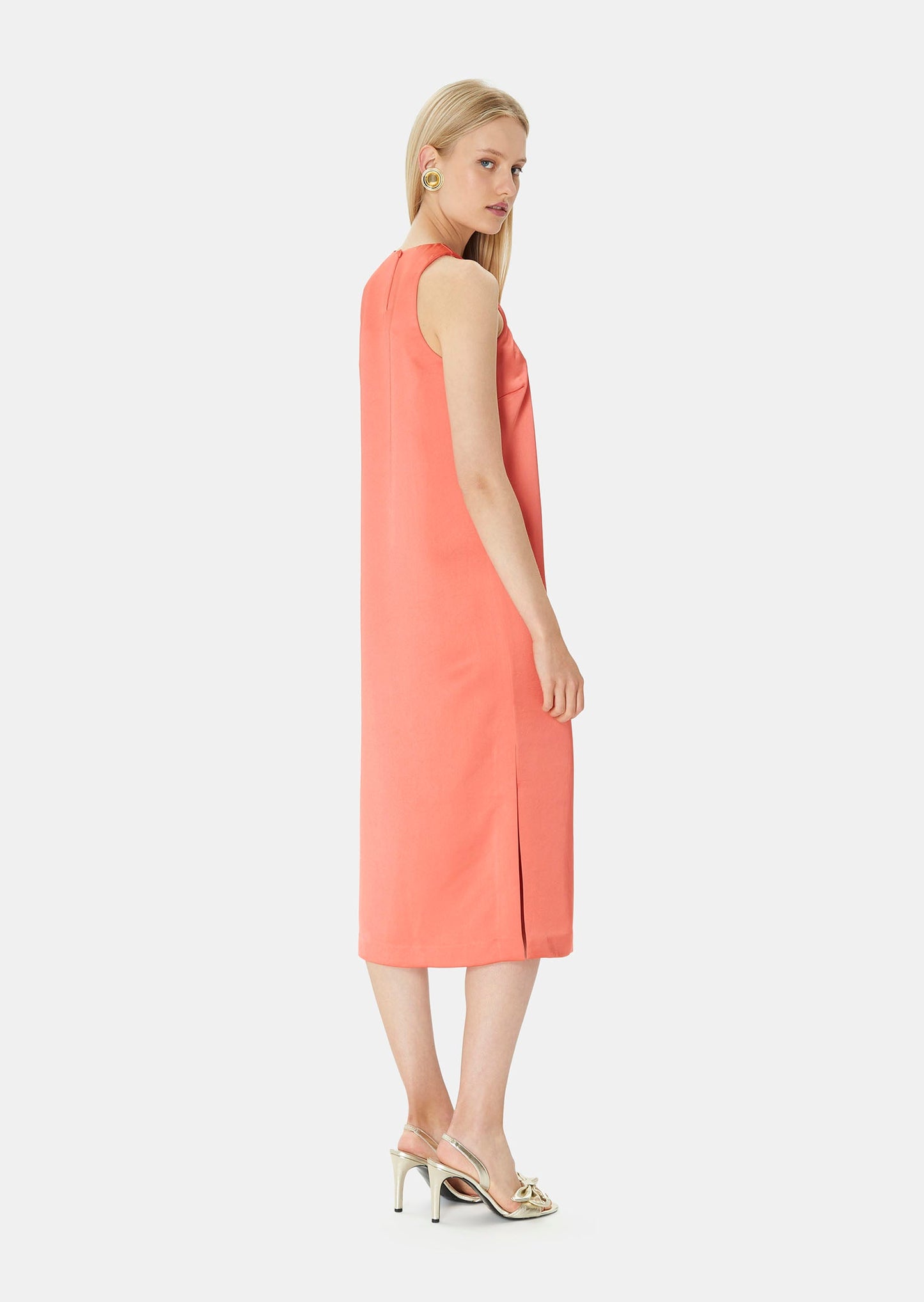 Long, sleeveless coral satin dress with a straight, flowing cut.