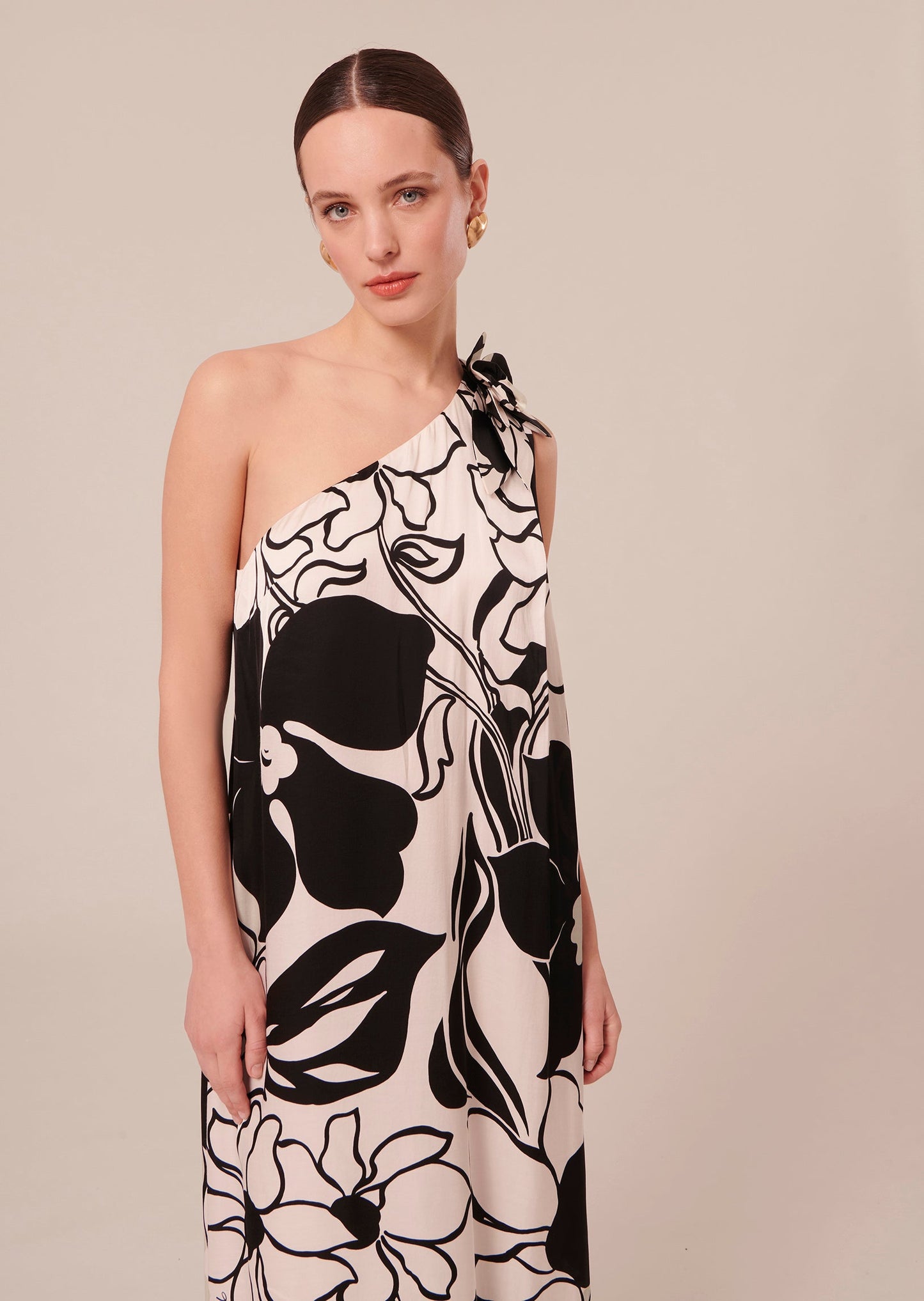 Model wearing Tara Jarmon asymmetrical ecru dress with floral print.