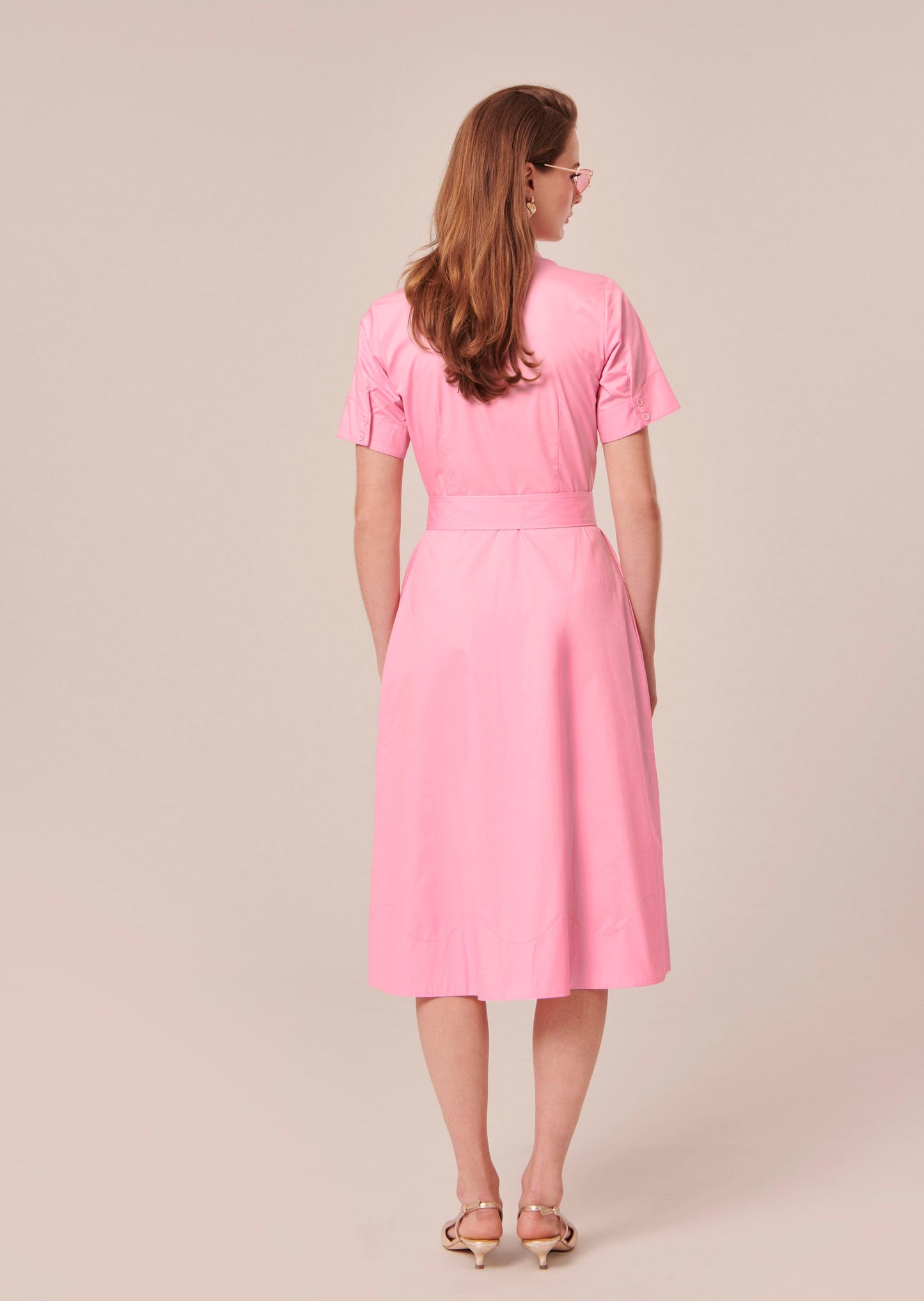 Flowing pink address with adjustable waist belt.