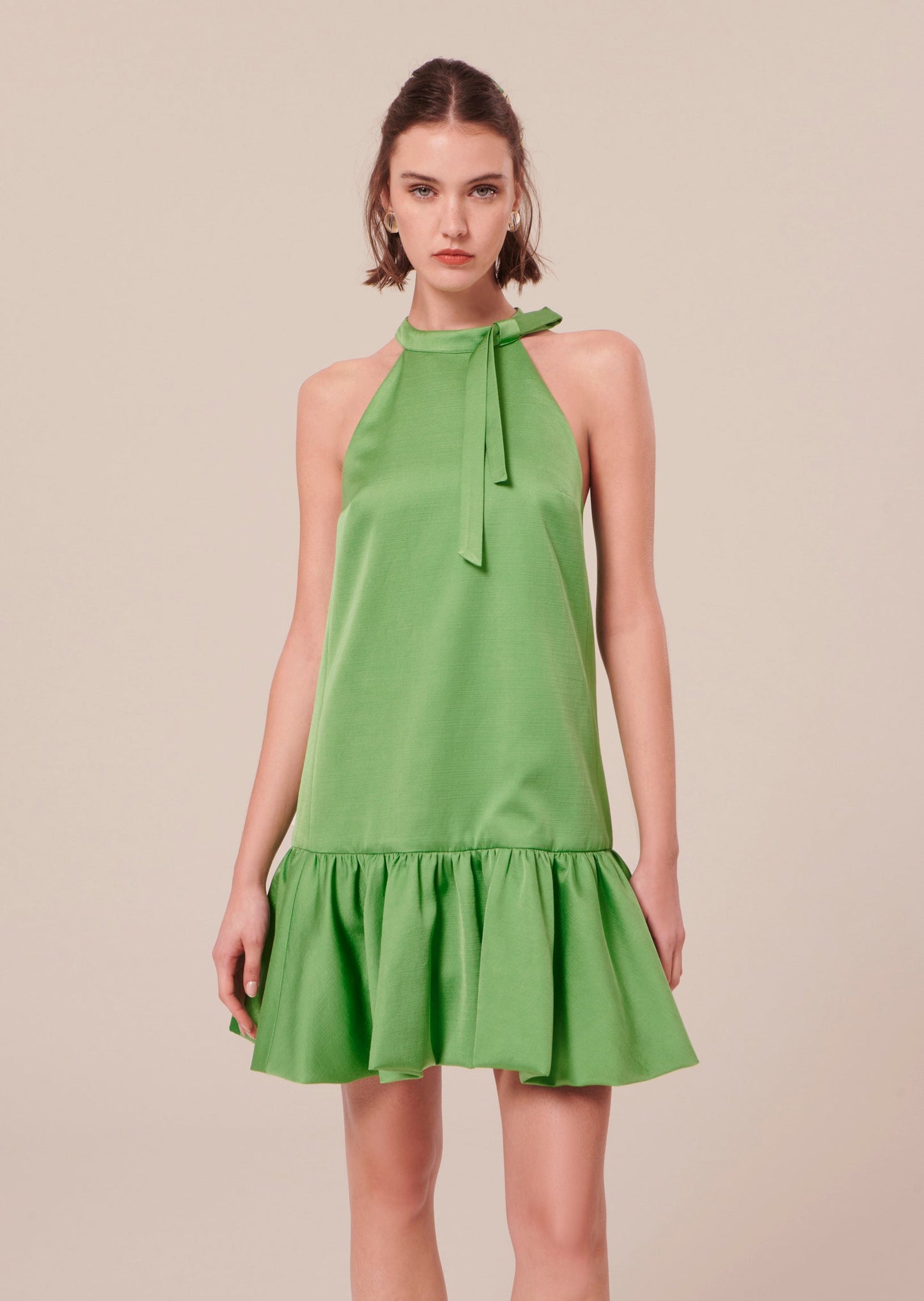 Model wearing Tara Jarmon Green Satin Short Dress.