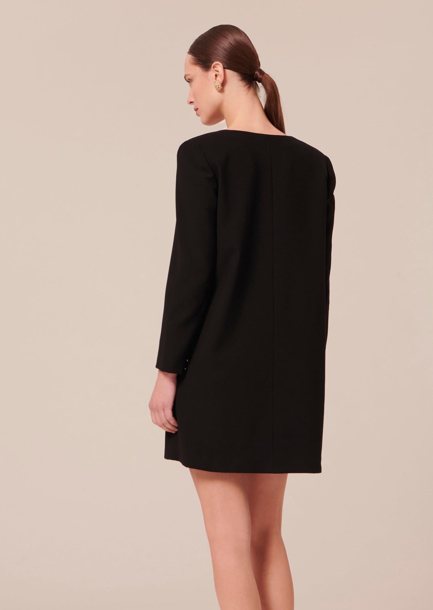 Straight cut short black crepe dress.