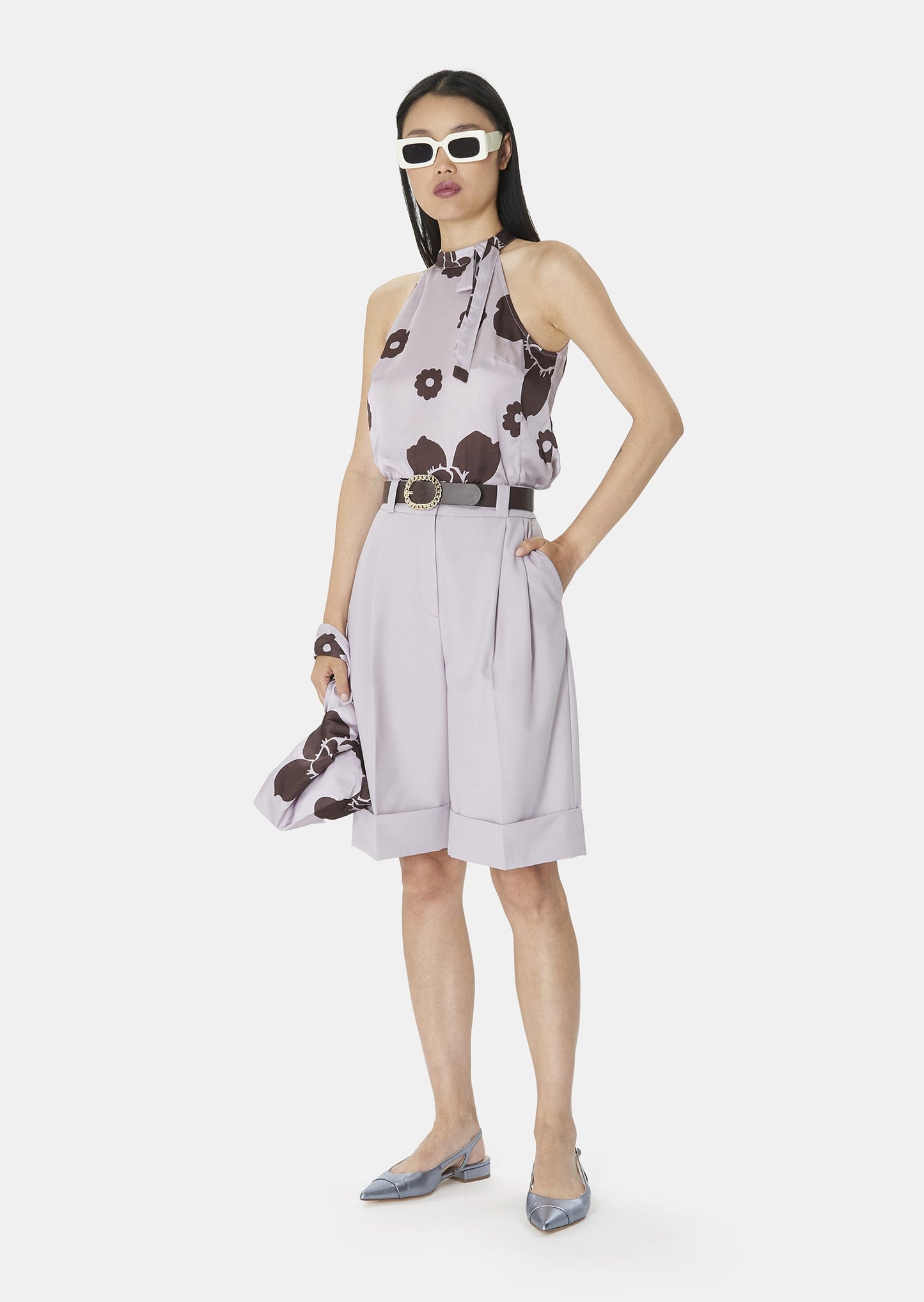 Light purple satin top; it has a straight, flowing cut and an American neckline that closes with two pearly buttons.