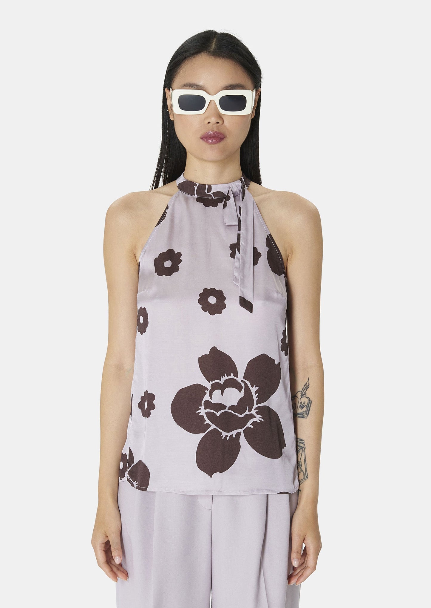 Model wearing Tara Jarmon Flowing Light Purple Top with Asymmetrical Neckline and Floral Print.