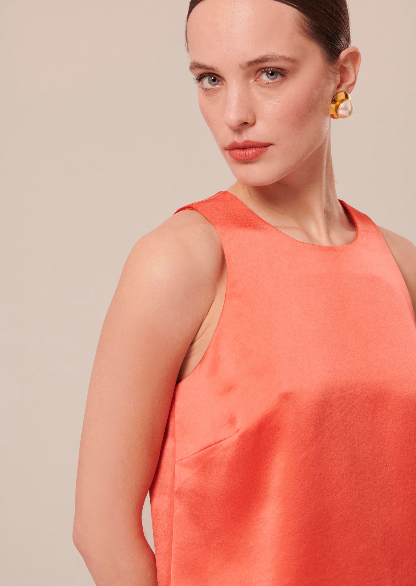 Sleeveless Top in Coral with Trapeze Silhouette.