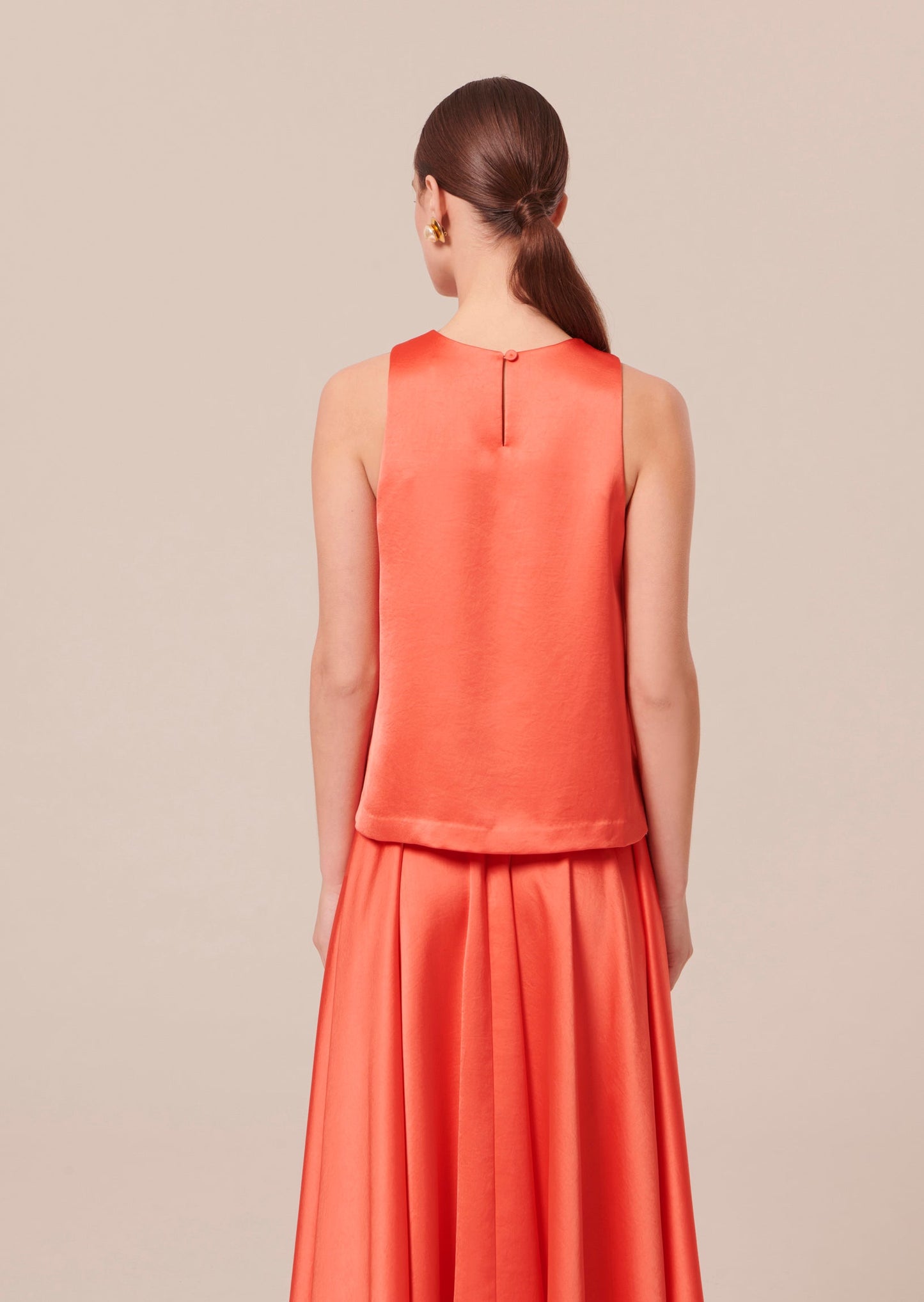 Coral Sleeveless Top with Relaxed Fit and Back Button Closure.
