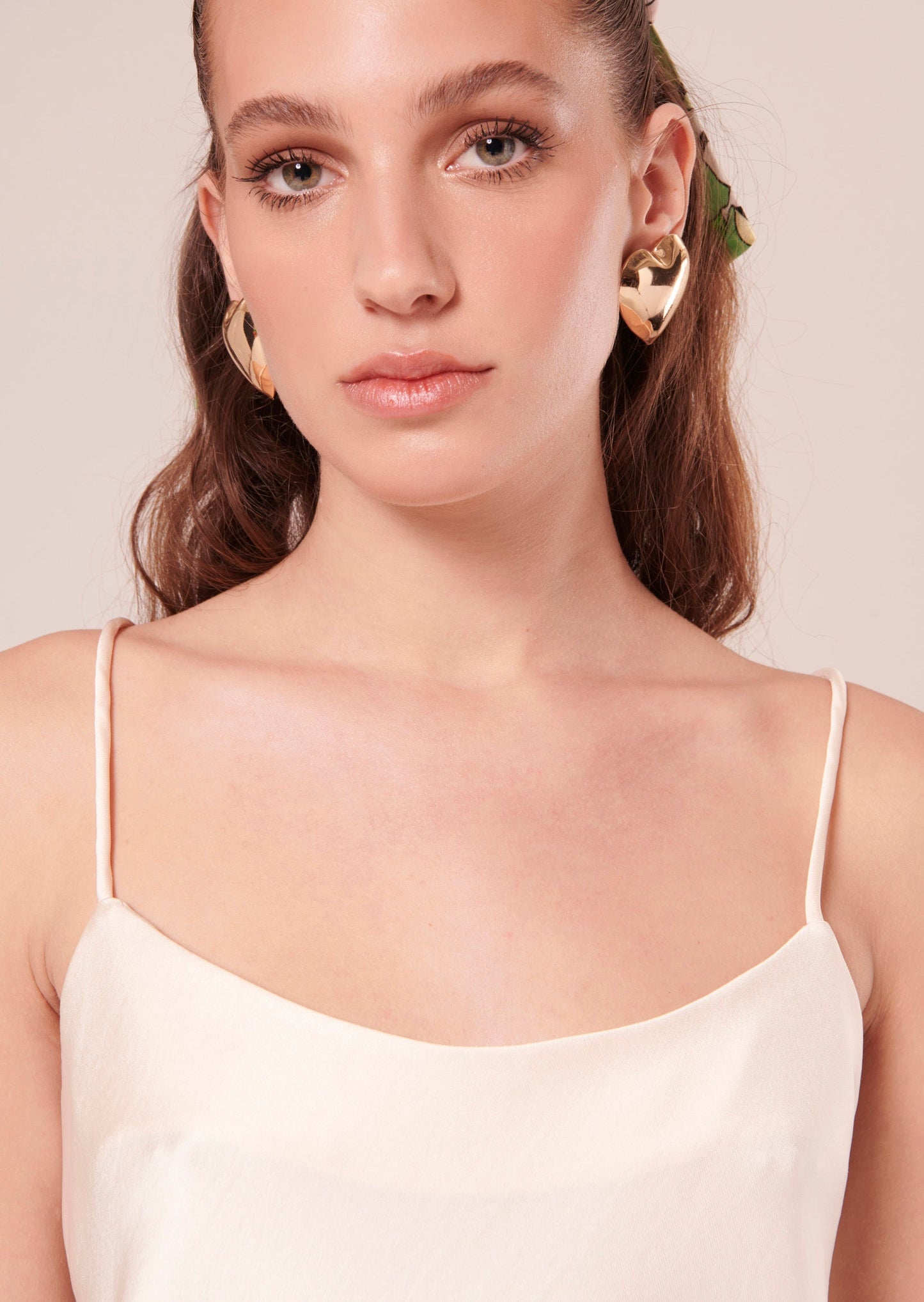 Off-white flowing satin tank top with thin straps.