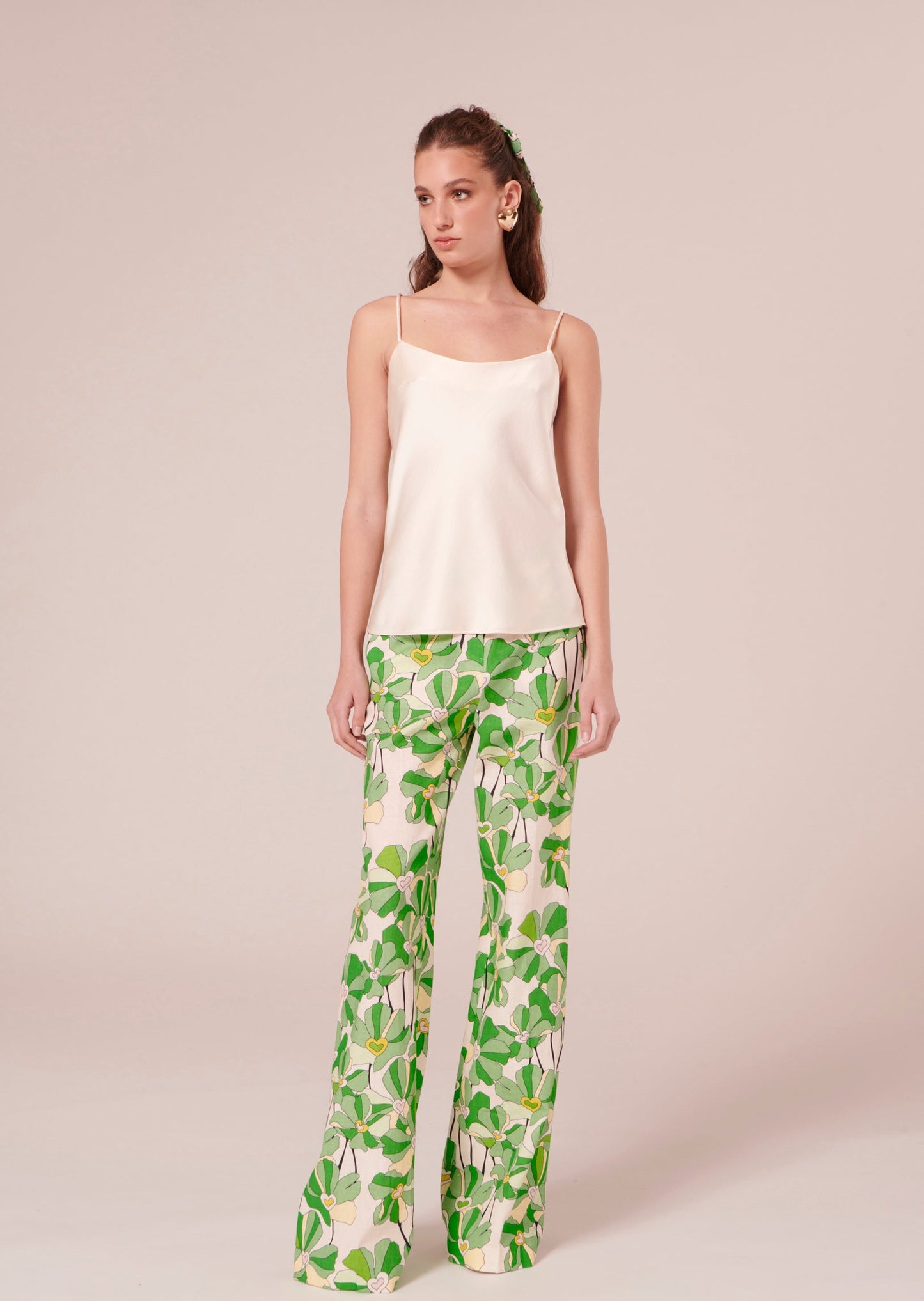 Off-white satin tank top with thin straps, matching with a flower printed wide leg satin pants.