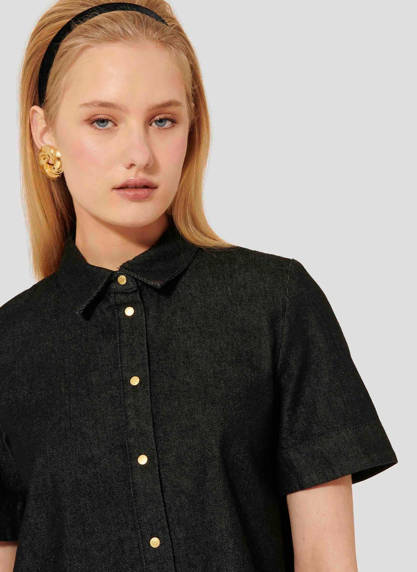 Black denim short sleeves shirt with gold buttons.
