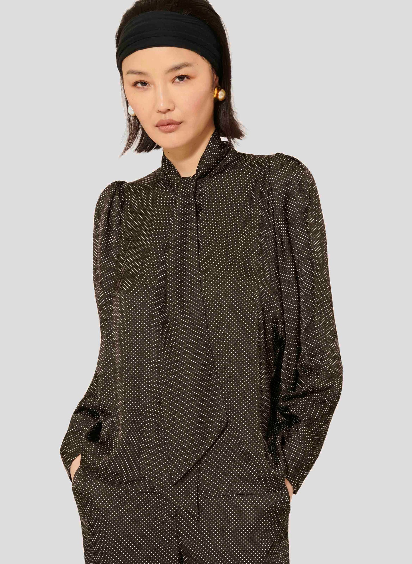 Black polka dot shirt with collar.
