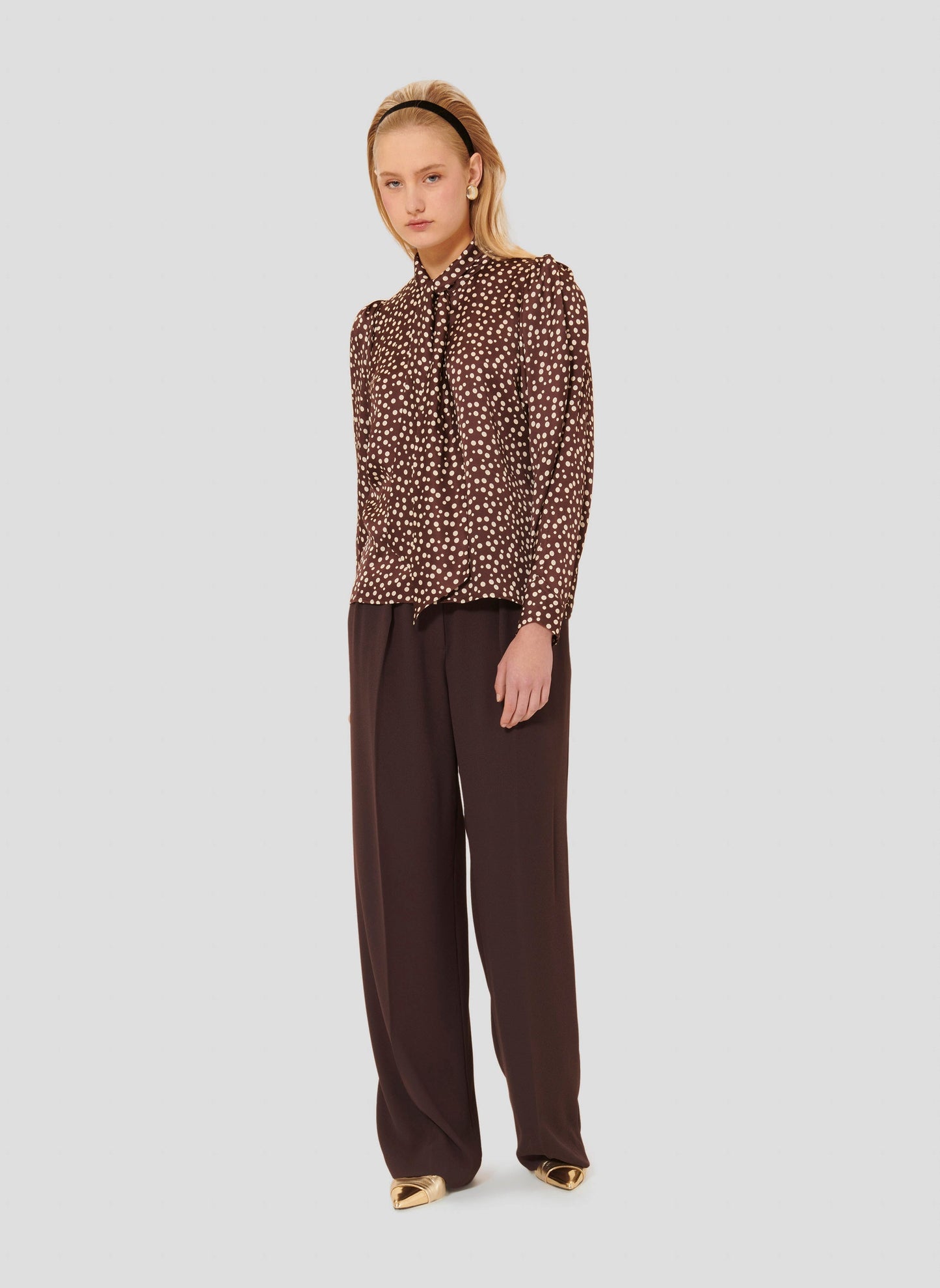 Puffed long sleeves brown shirt with white polka dots.