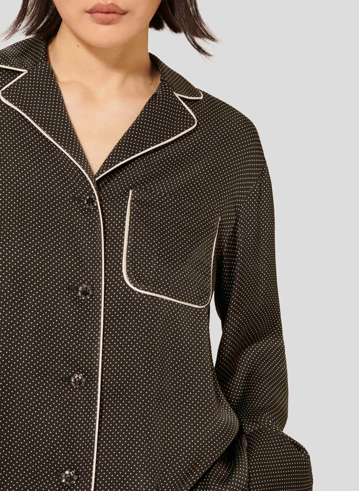 Black and white polka dot shirt with black and silver jewel buttons.
