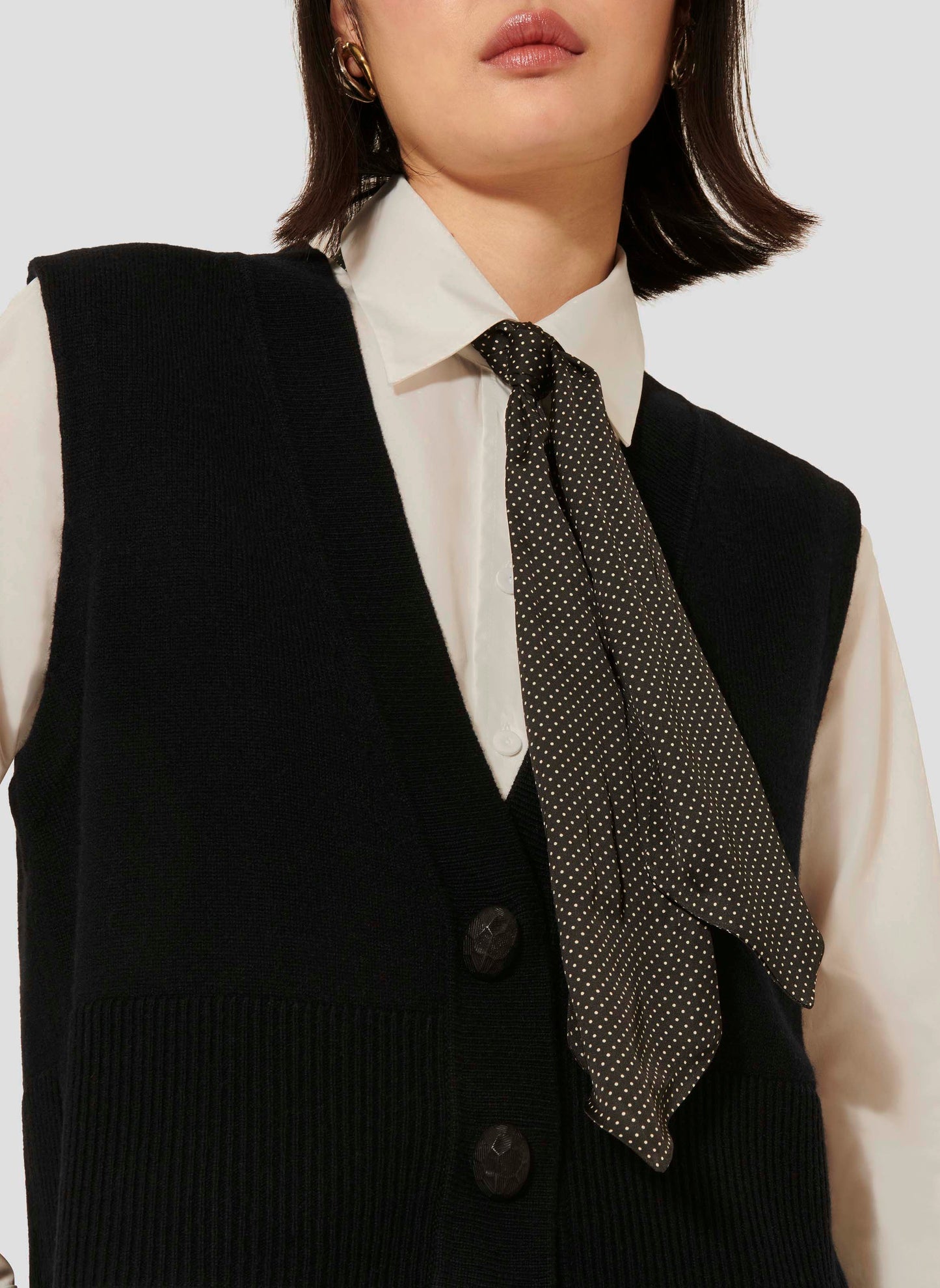 Tara Jarmon close up sleeveless black cardigan in merino wool and alpaca.