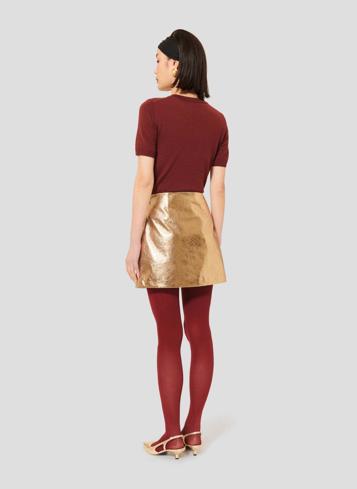 Versatile Skirt in Gold with Trapeze Cut and Simple Design matching with a Burgundy Short Sleeves Top.