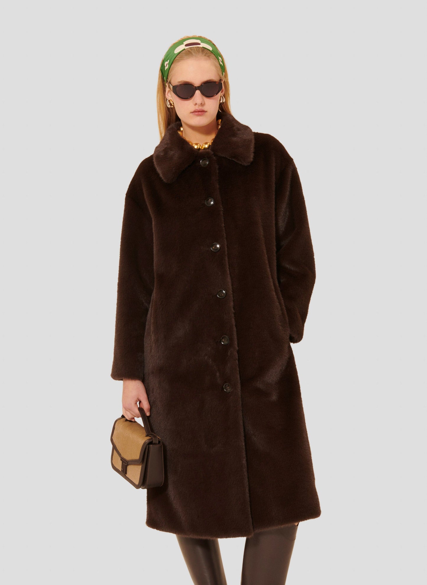 Tara Jarmon model wearing brown faux fur coat.