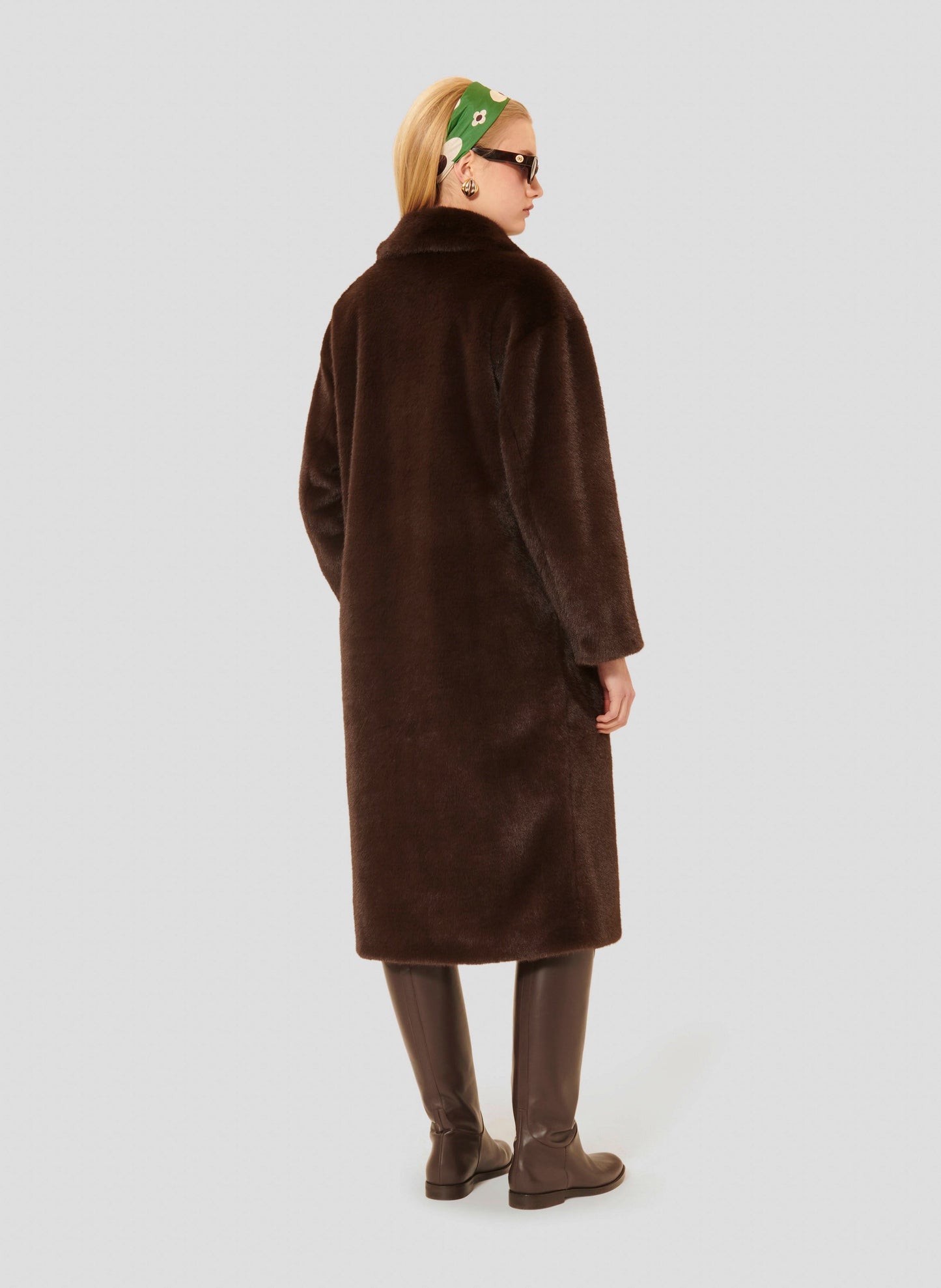 Tara Jarmon model wearing long chocolate faux fur coat.