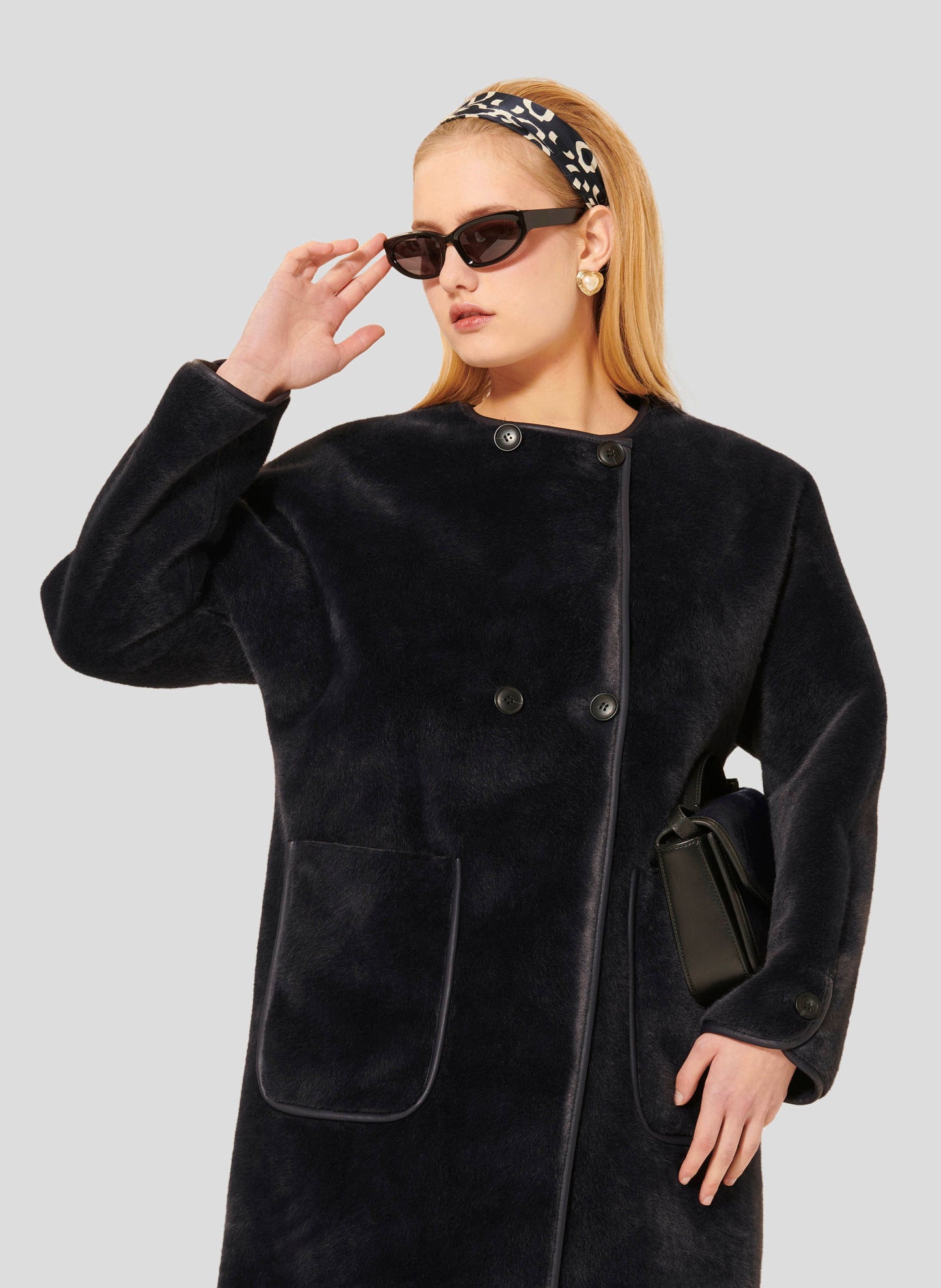 Tara Jarmon model wearing midnight blue faux fur coat.