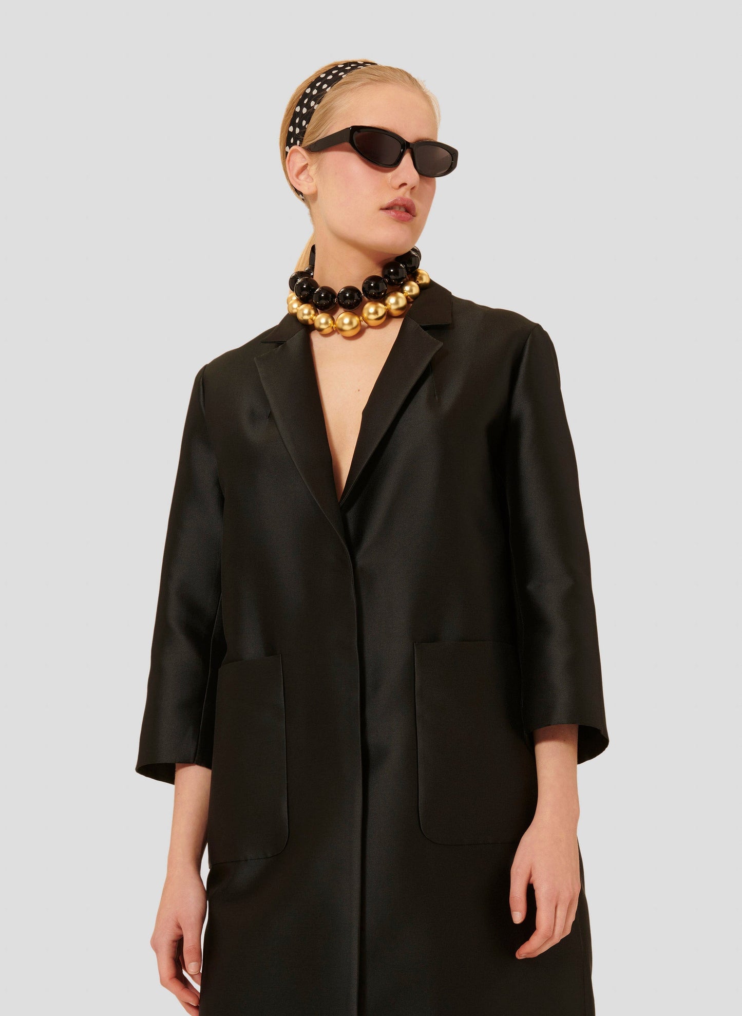 Tara Jarmon model wearing black satin coat.
