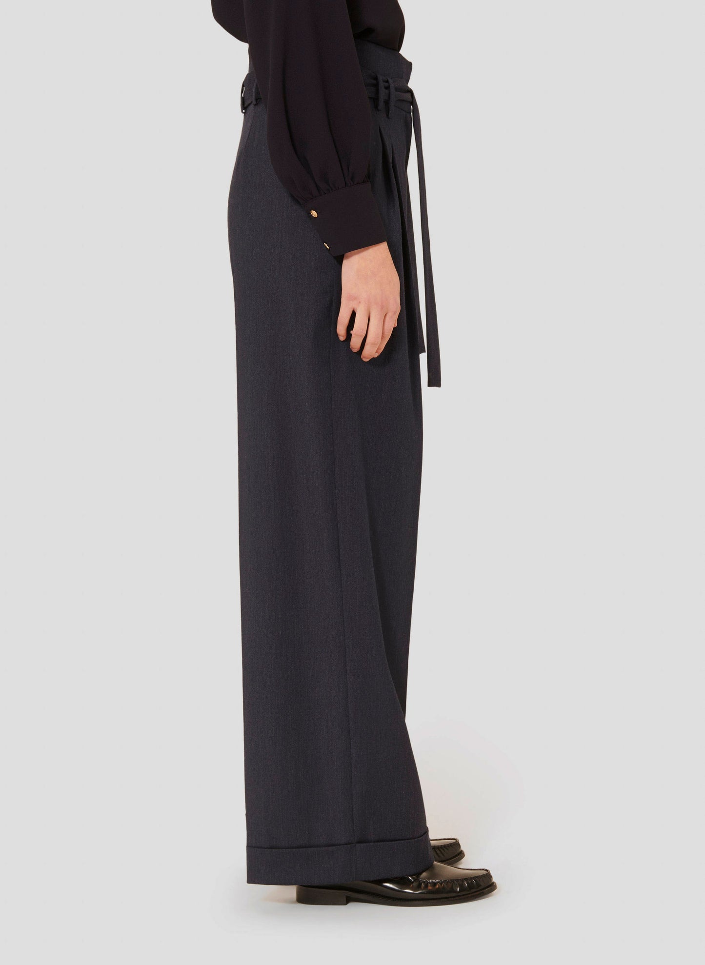 High-Waisted Pants in Dark Blue with Pleated Front and Cuffed Hem.