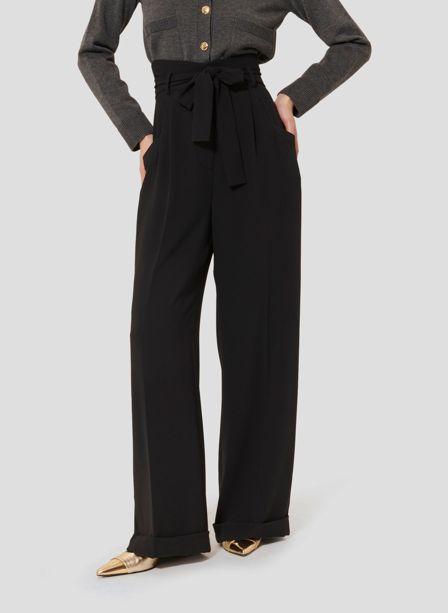 High-Waisted Pants in Black with Pleated Front and Cuffed Hem.