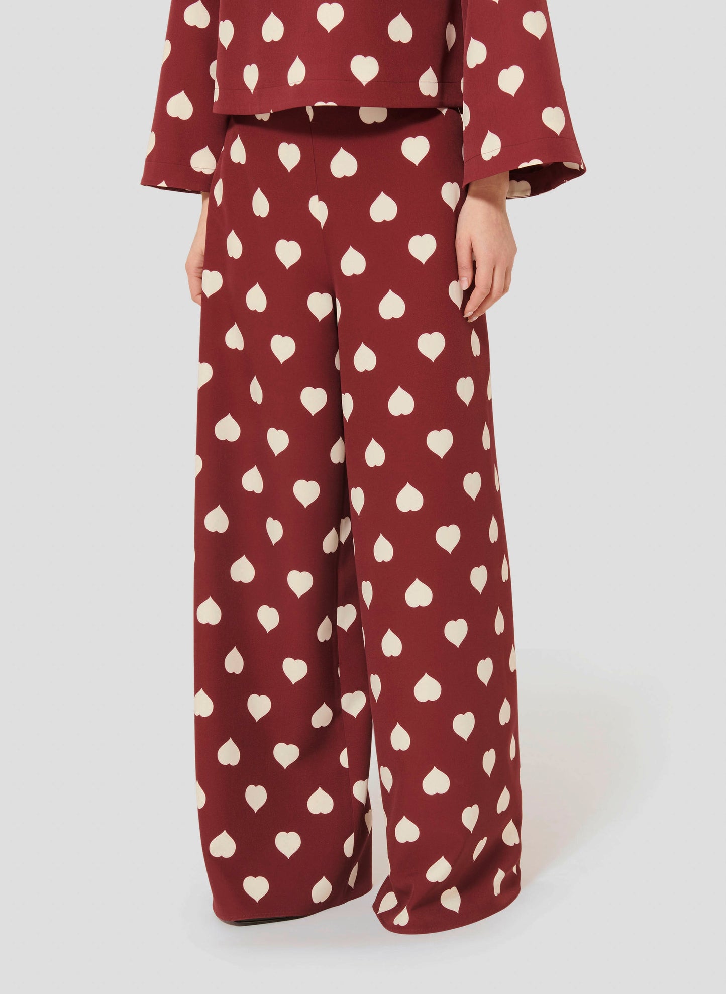 Stylish Burgundy Pants with Heart Print and Flowing Silhouette.