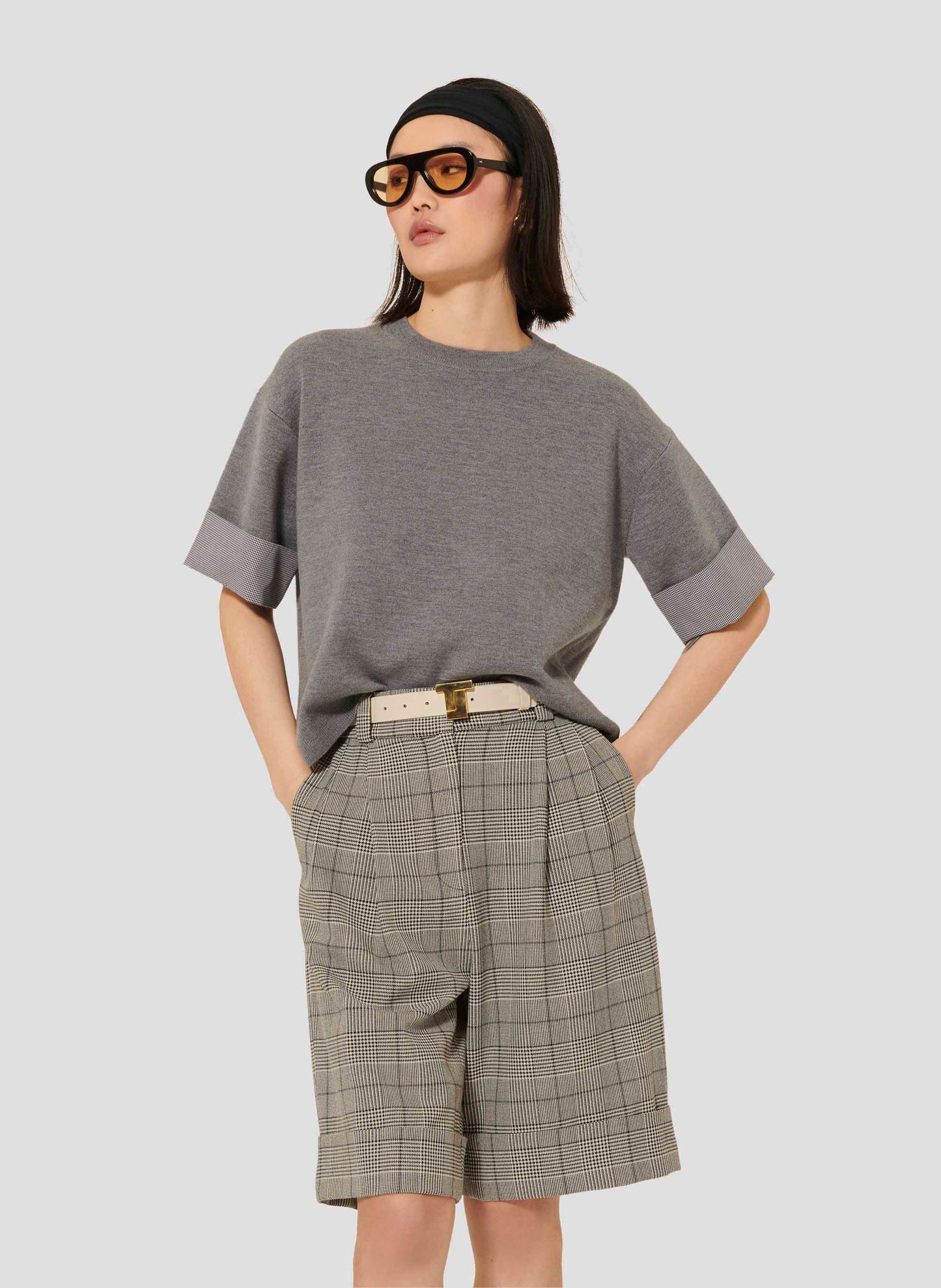 Model wearing Tara Jarmon Cropped Merino Wool Sweater in Grey with Gingham Trim.