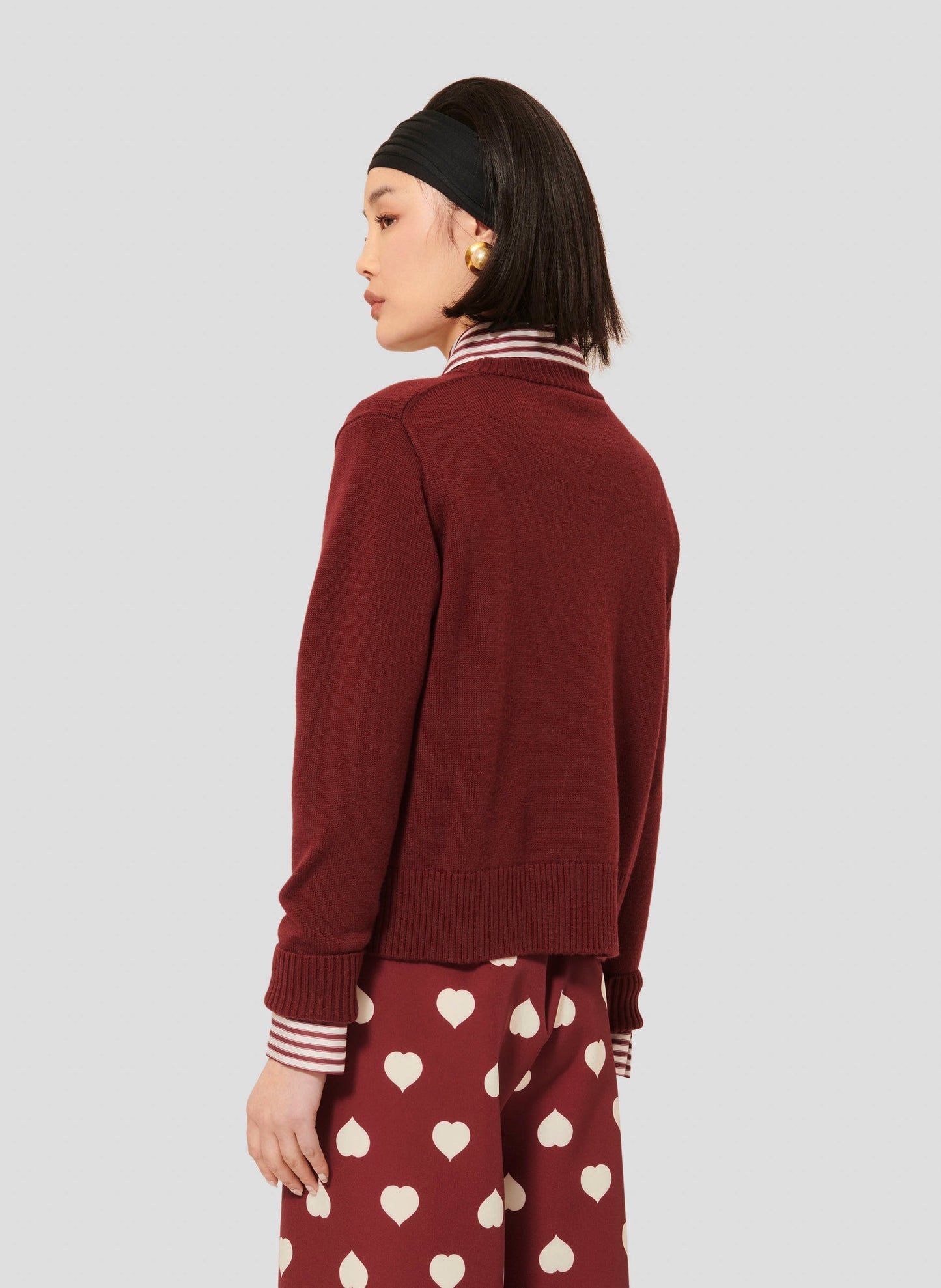 Cozy Burgundy Sweater with Embroidered Design and Ribbed Trim.