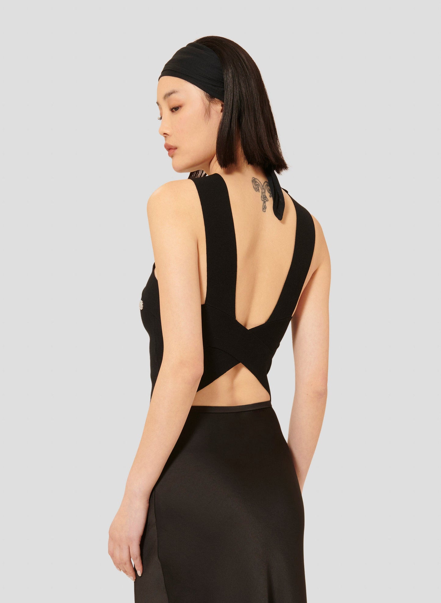 Stylish Black Crop Top with Waffle Knit Texture and Pearl Accents.