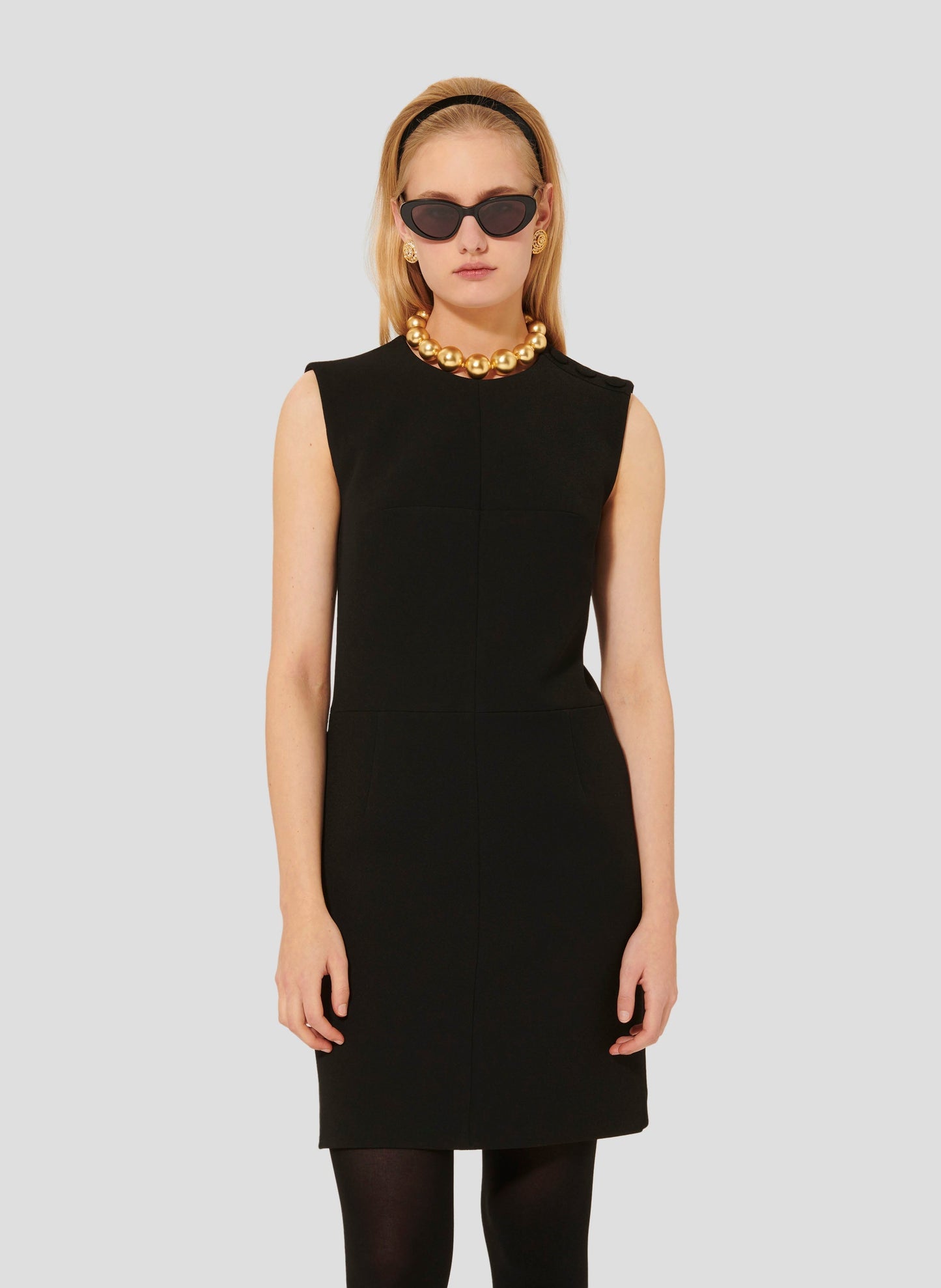 Model wearing Tara Jarmon short black crepe dress.