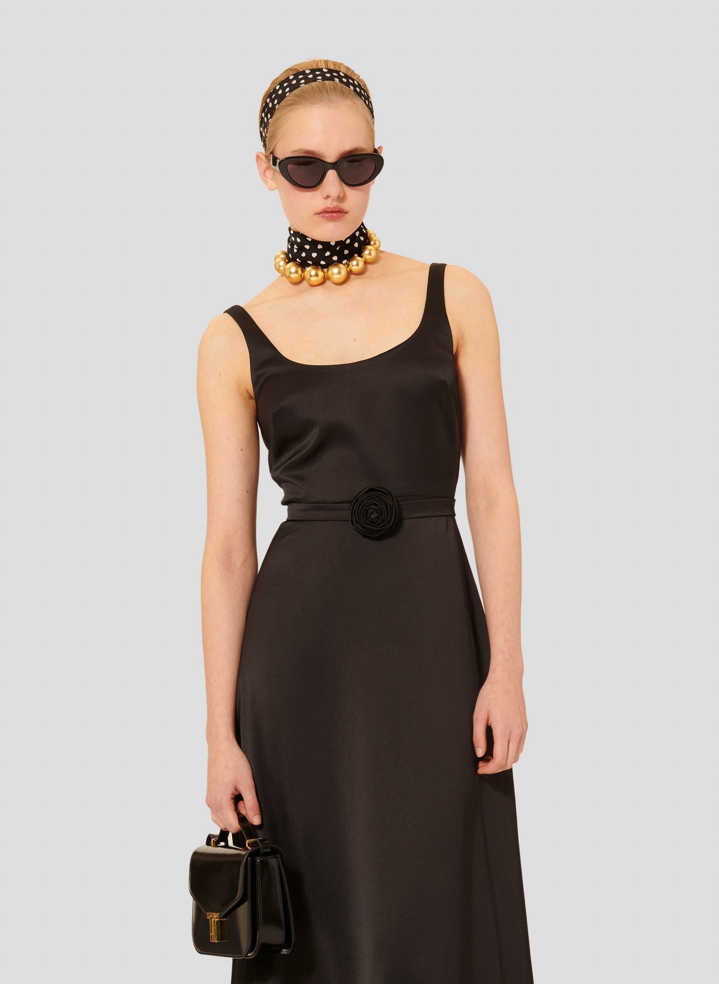 Model wearing Tara Jarmon black flowing satin long dress.