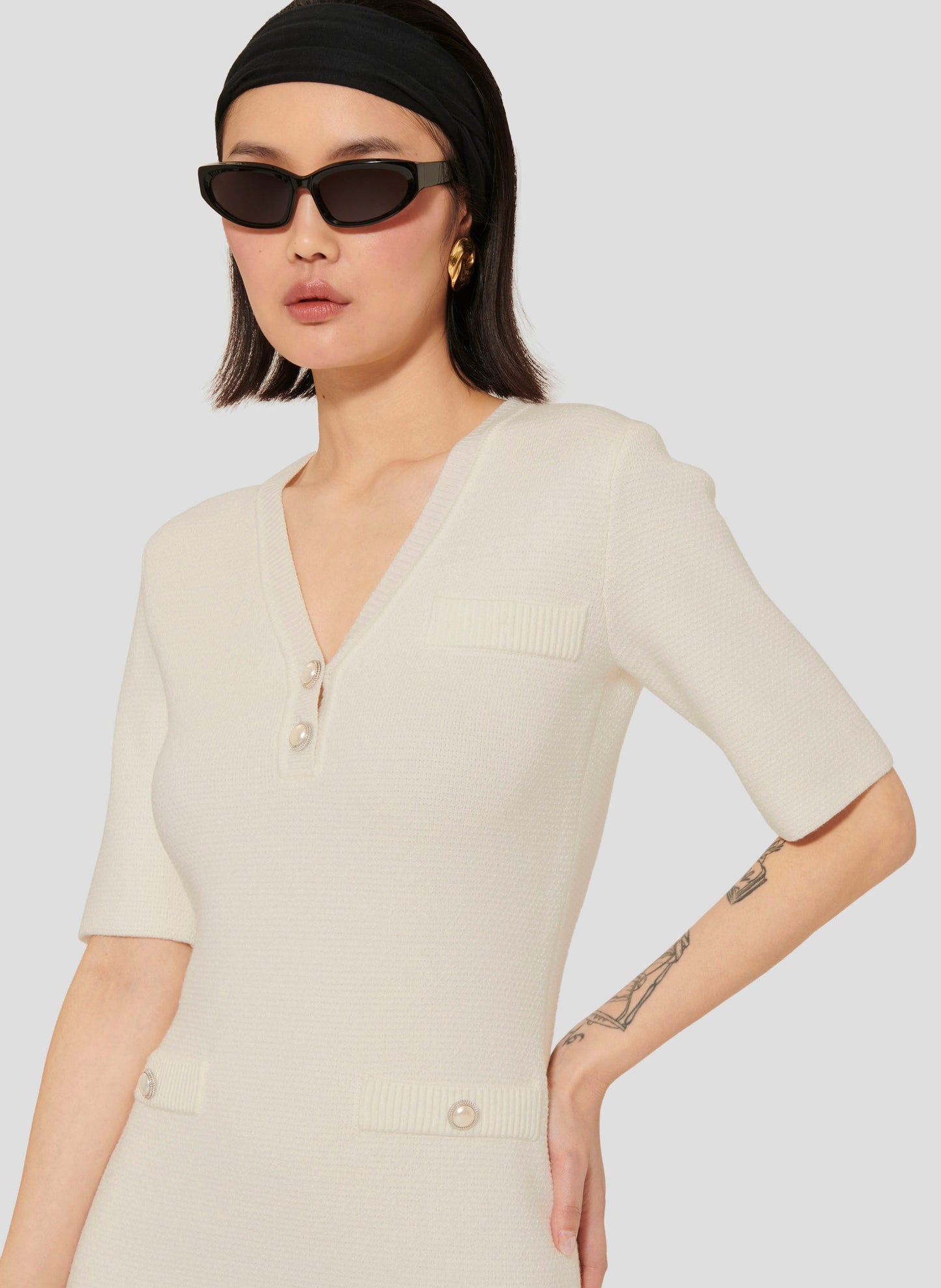 Ecru Fitted Knit Dress with Side Pockets and Pearl Buttons.