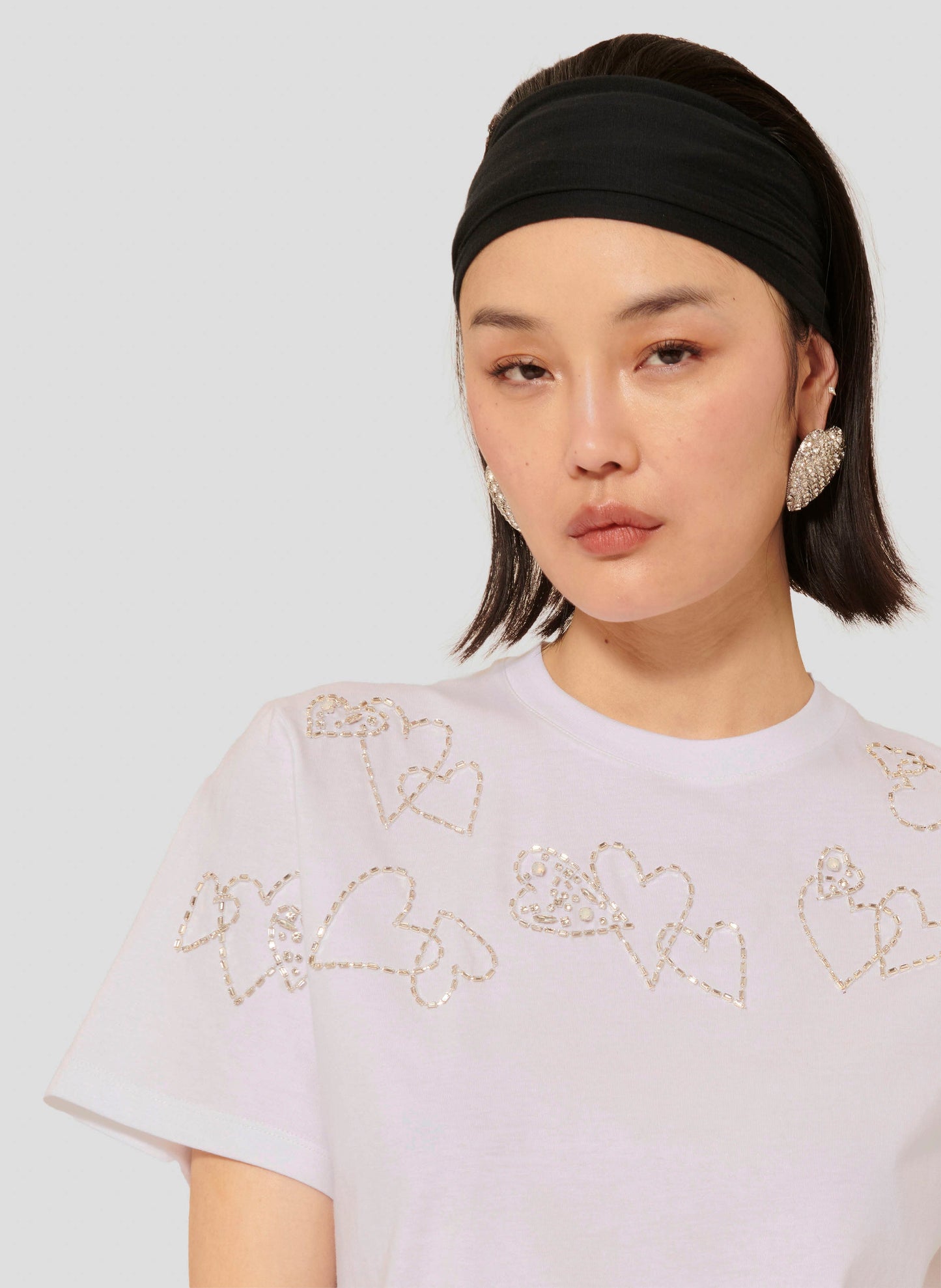 White Short Sleeves T-shirt with Round Neckline and Decorative Heart Details.