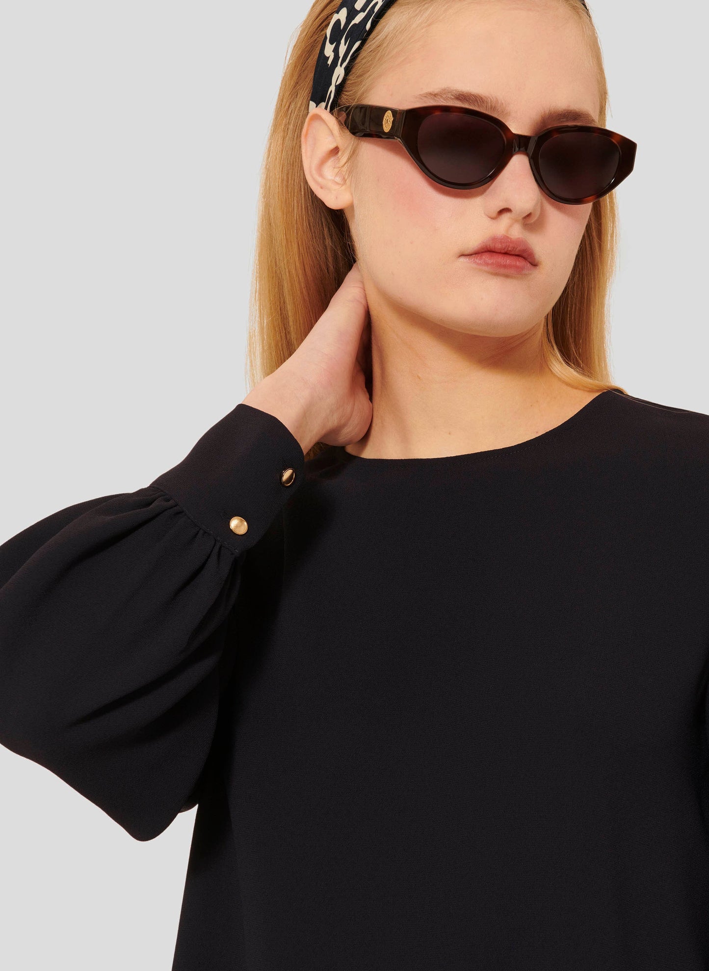 Round Neck Top in Dark Blue with Gold Button Closure.