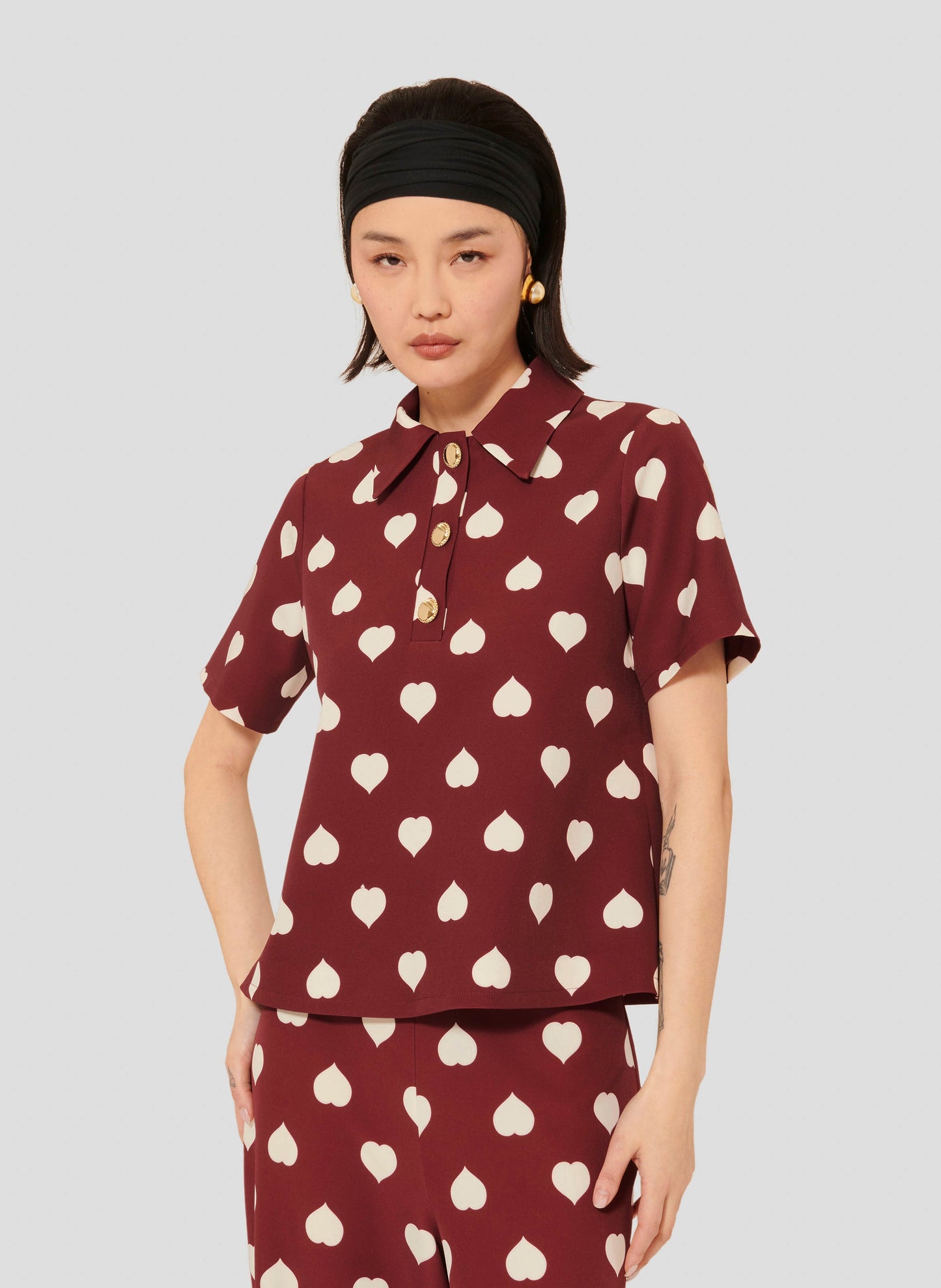 Stylish Burgundy Top with Heart Print and Gold Buttons.
