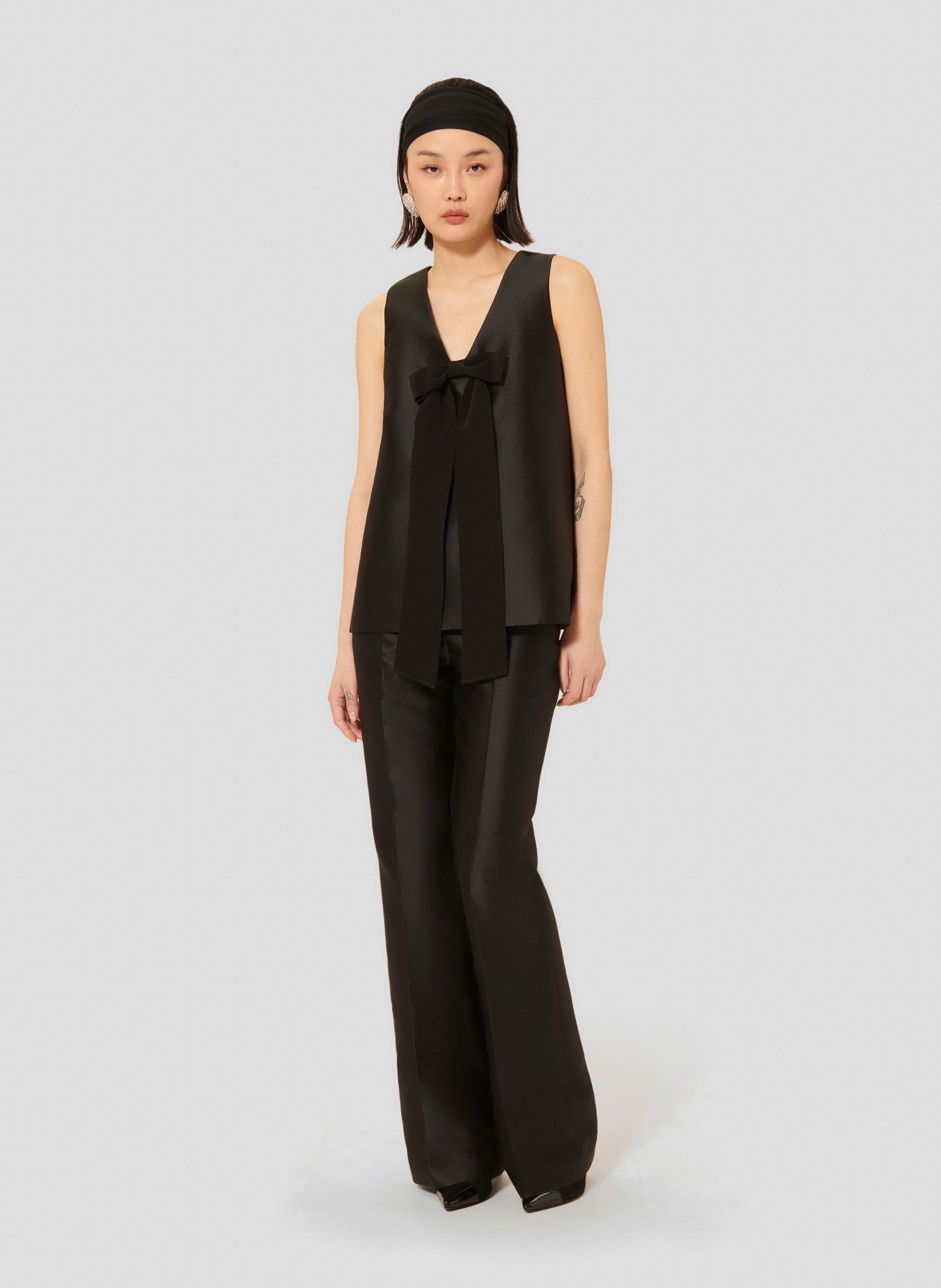 Versatile Black Top with Satin Finish and Minimalist Design Matching with Flowing Black Satin Pants.