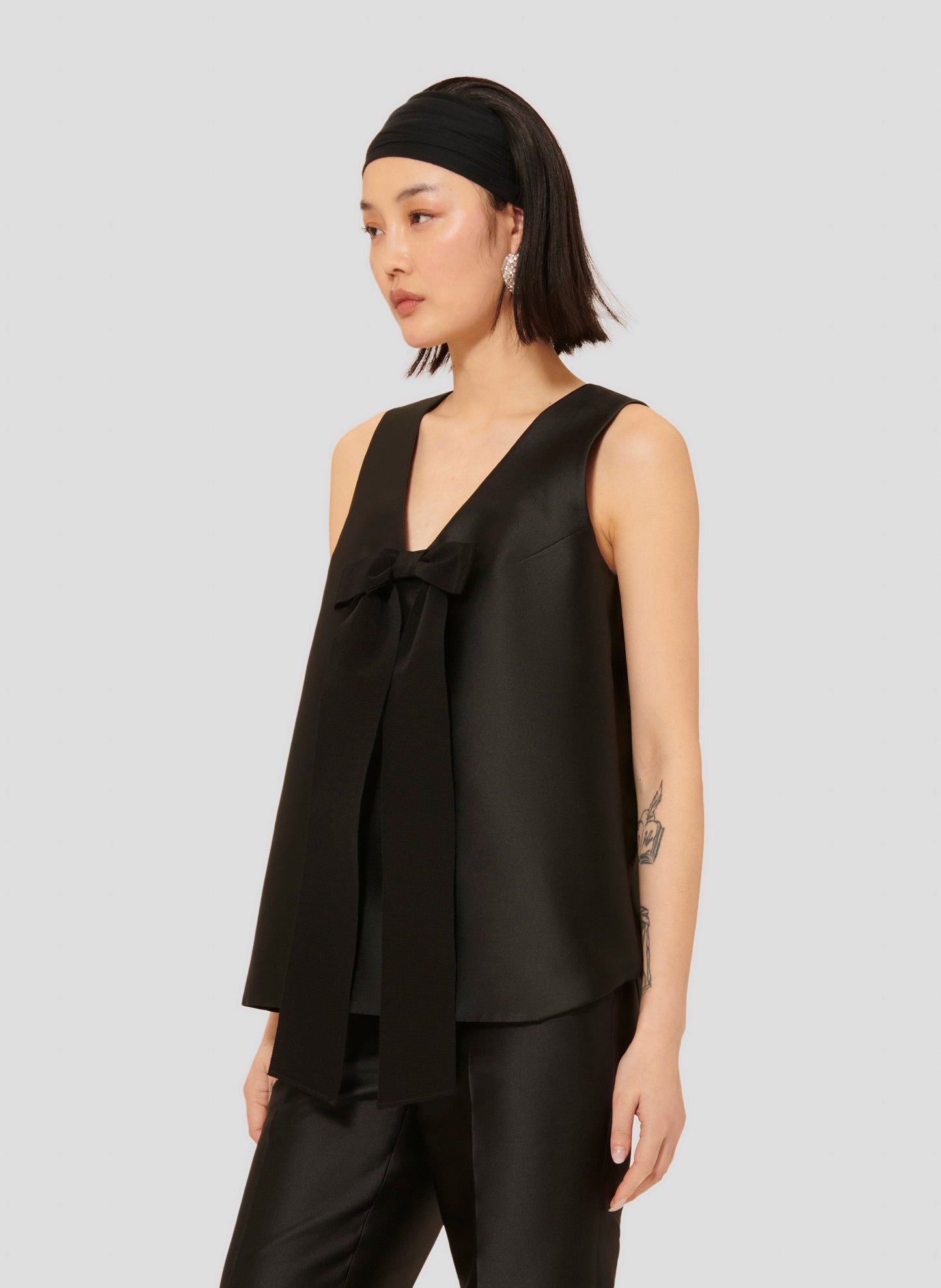 Black Satin Top with V-Neck and Bow Detail.