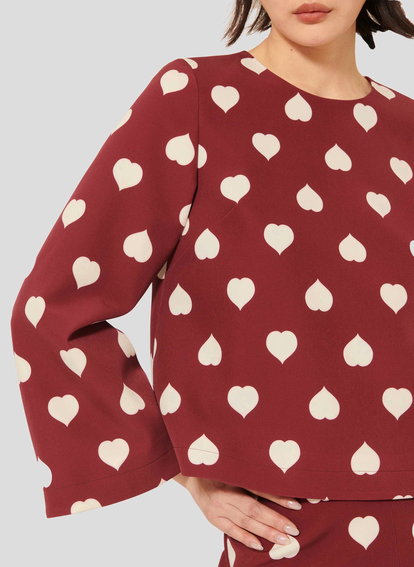 Flowy Top in Burgundy with Round Neckline and Heart Detail.