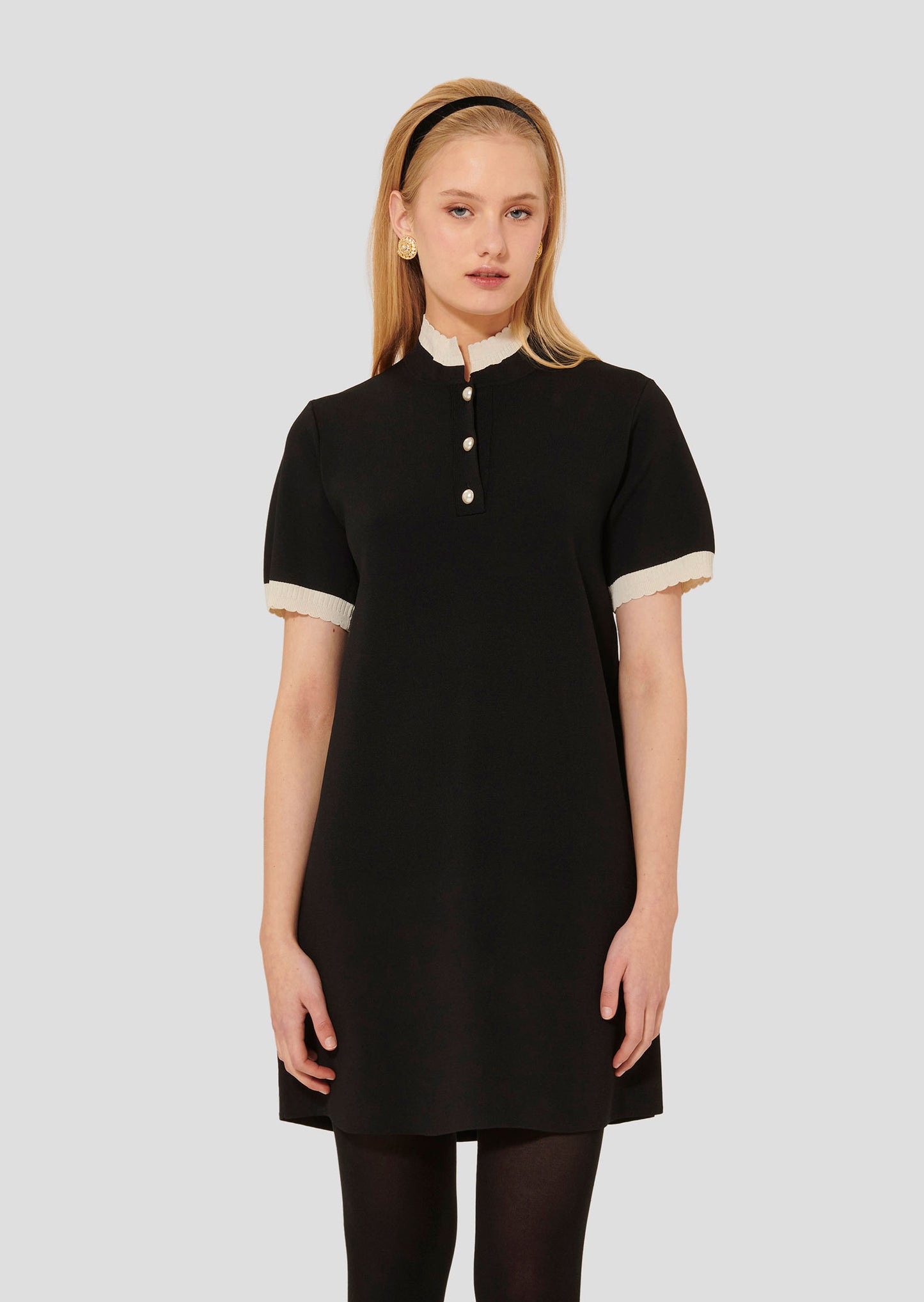 Model wearing Tara Jarmon short black knitted dress.